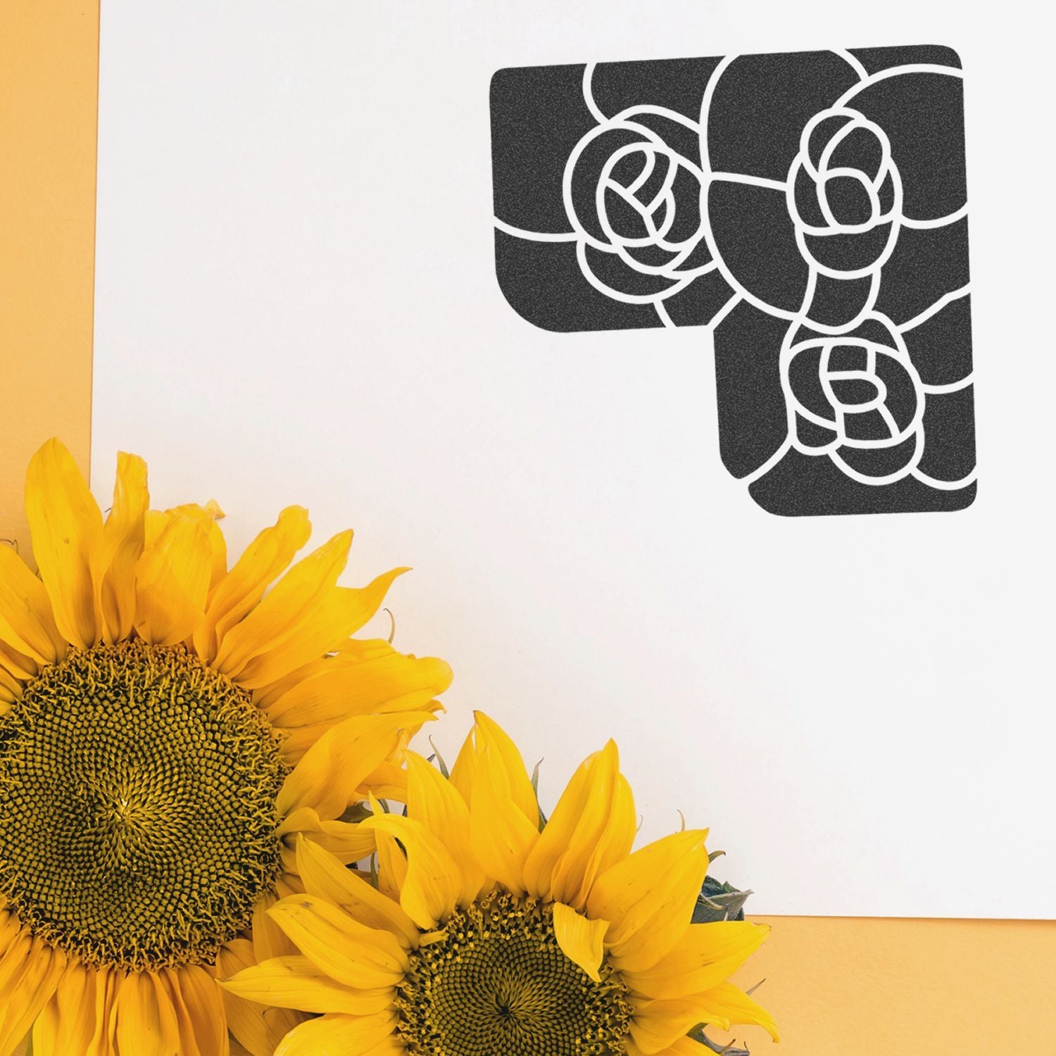 Bright yellow sunflowers with a black floral monogram design on a white background, stylish botanical wall art and decor.