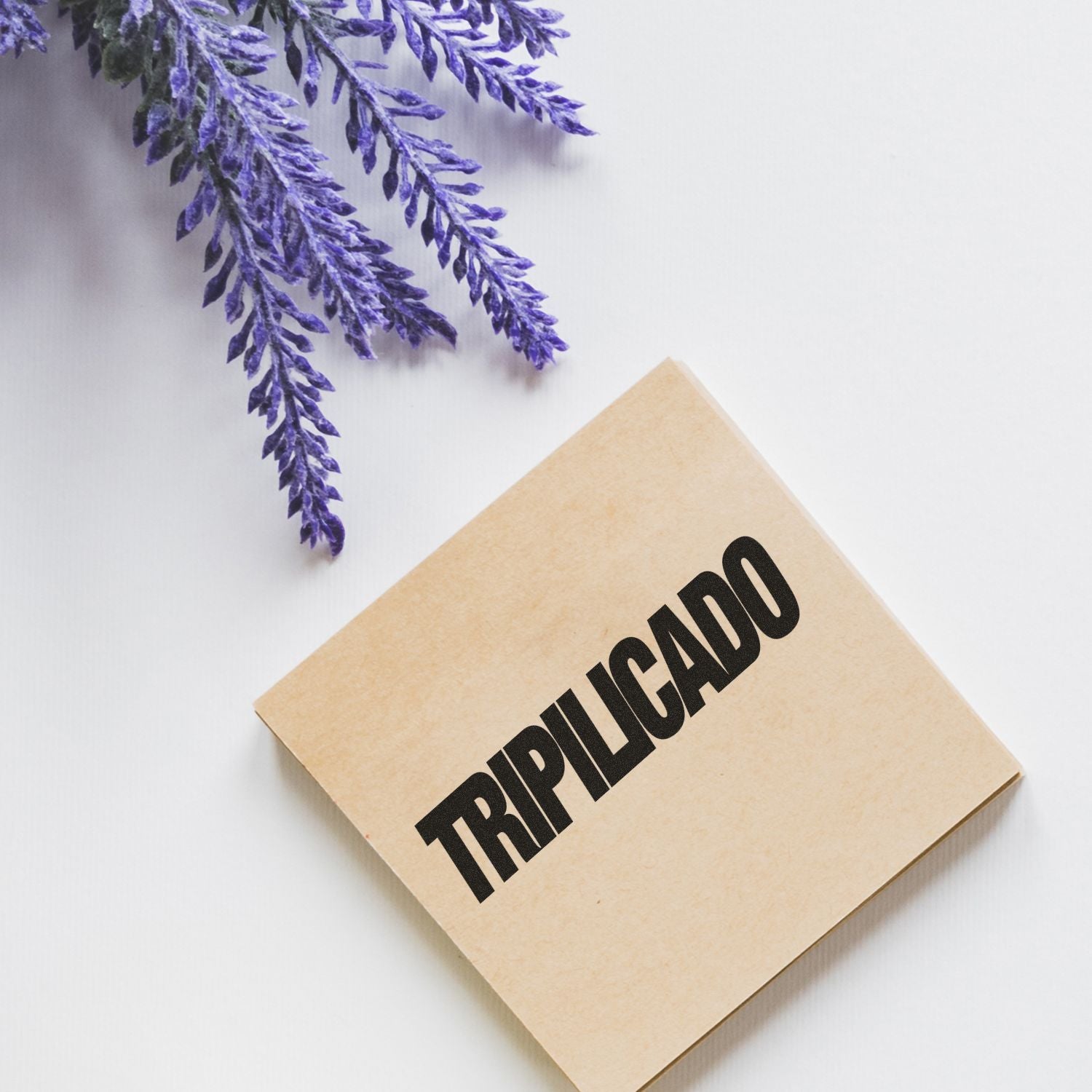 Top view of kraft gift box with bold black lettering and purple lavender sprigs on a white background for branding.