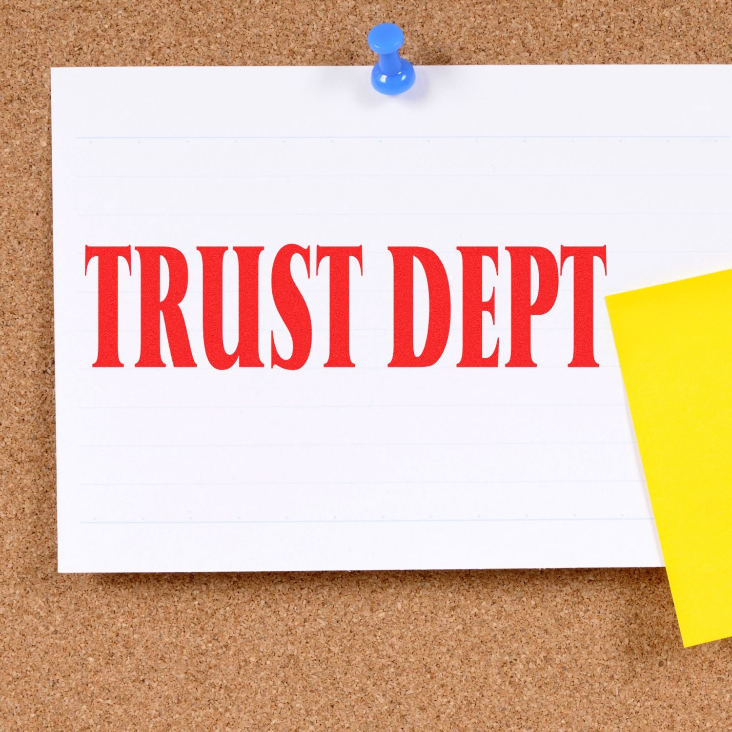 Trust department sign pinned to a corkboard with a blue pushpin and yellow sticky note.