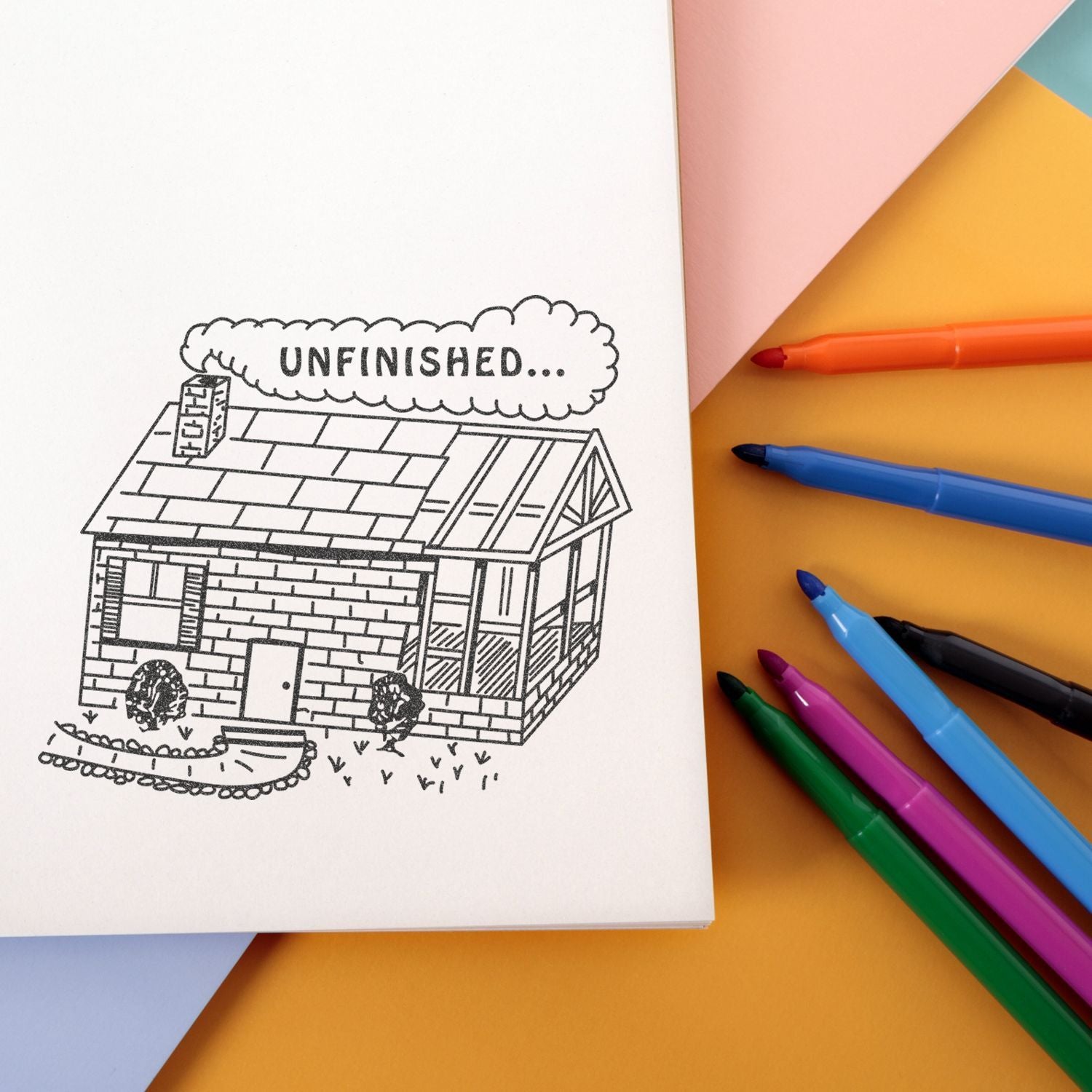Unfinished house coloring page with colorful markers on a pastel background, creative sketchbook art project.