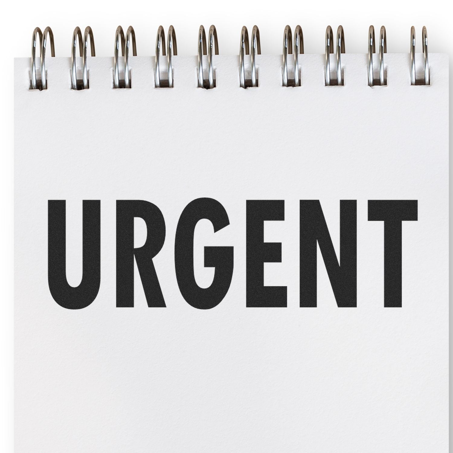 Spiral notebook page with bold URGENT text, emphasizing an important priority or deadline.