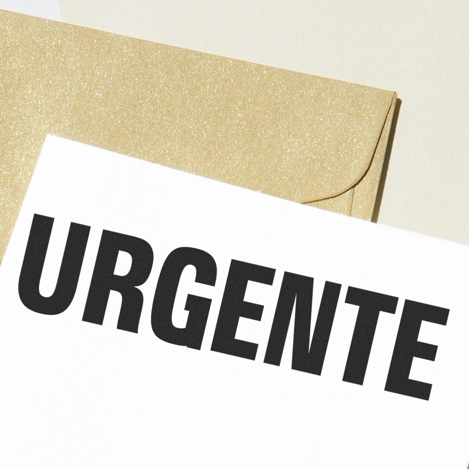 URGENT priority mail label on a gold glitter envelope, used to convey urgent shipping and delivery.