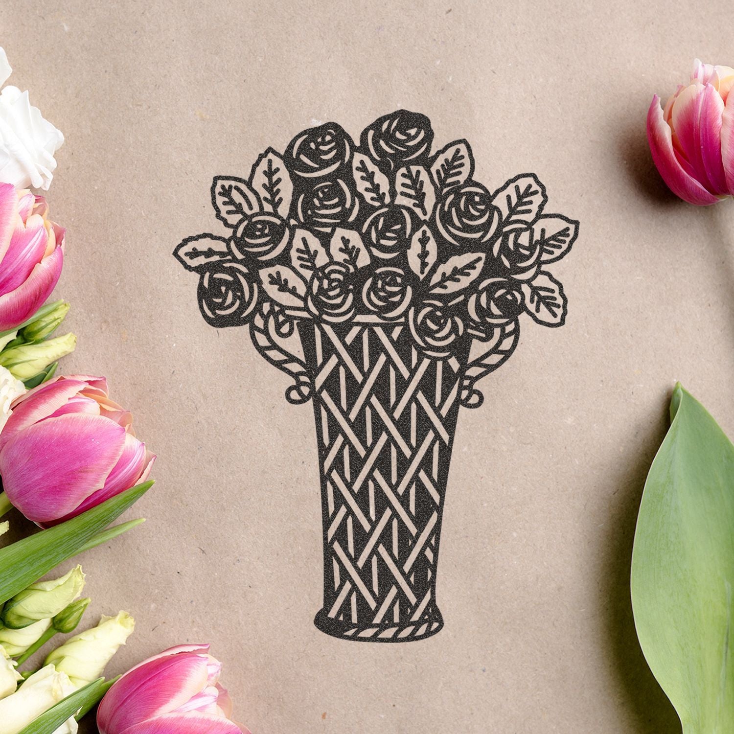 Black floral bouquet vase illustration on kraft paper with pink tulips and green leaves around the edges, elegant botanical design.