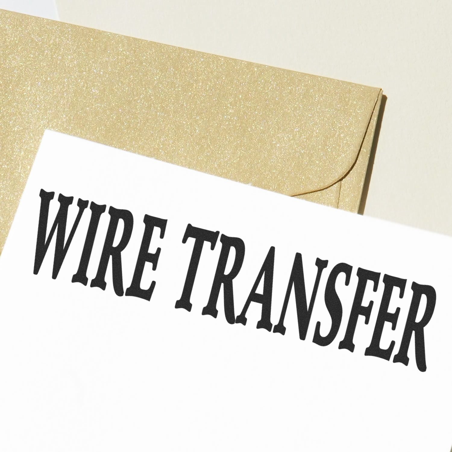 Gold envelope with Wire Transfer text on a white card, financial payment concept