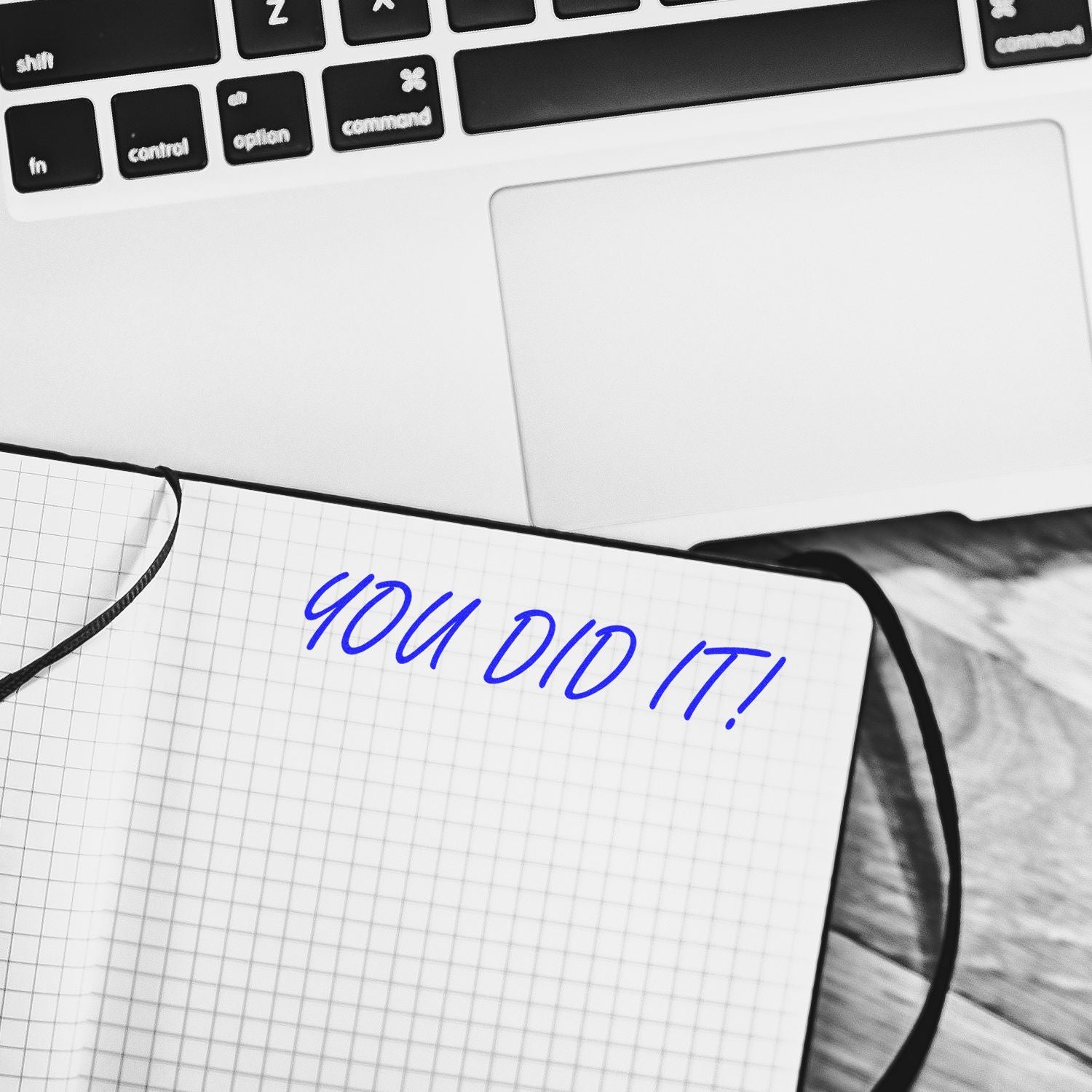 Top view of laptop keyboard and notebook with You did it! written, concept of success, achievement, and motivation.