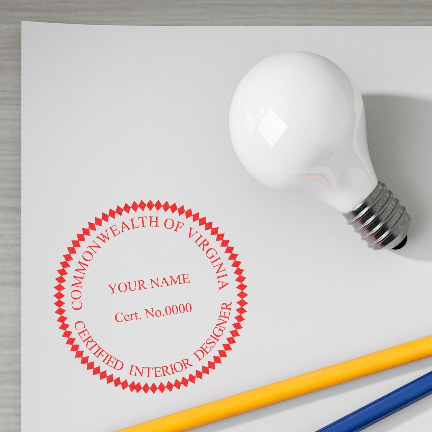 Commonwealth of Virginia certified interior designer seal on white paper with light bulb and pencils, branding mockup.