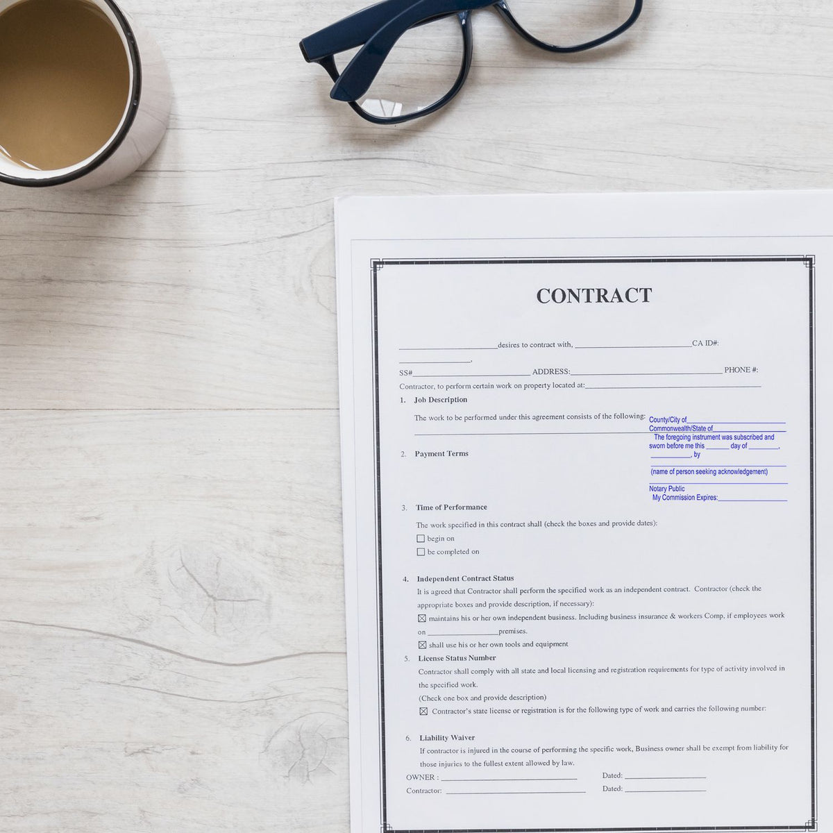 Top view of business contract paperwork on a desk with eyeglasses and coffee mug, legal agreement document ready for signing.