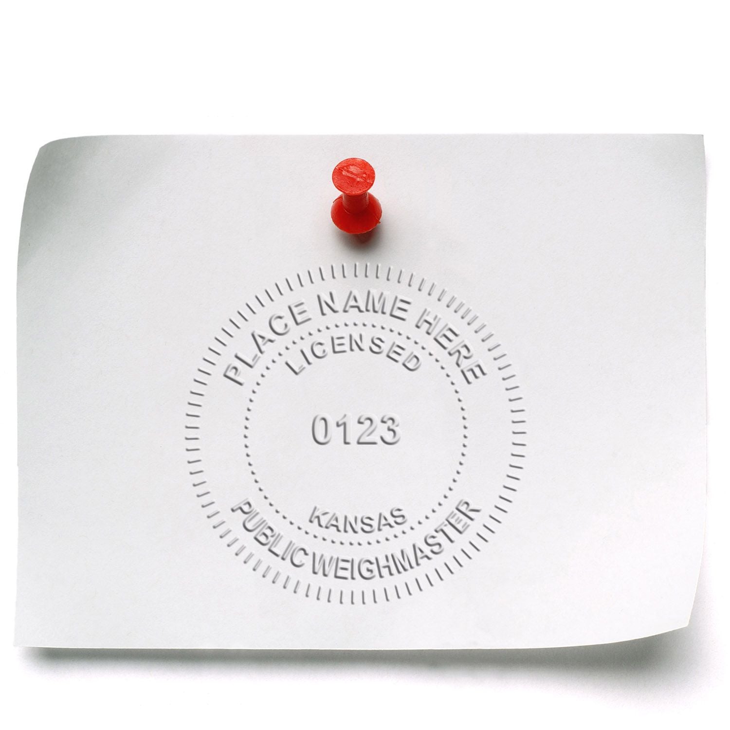 Embossed Kansas public weighmaster license form pinned with a red pushpin on white paper