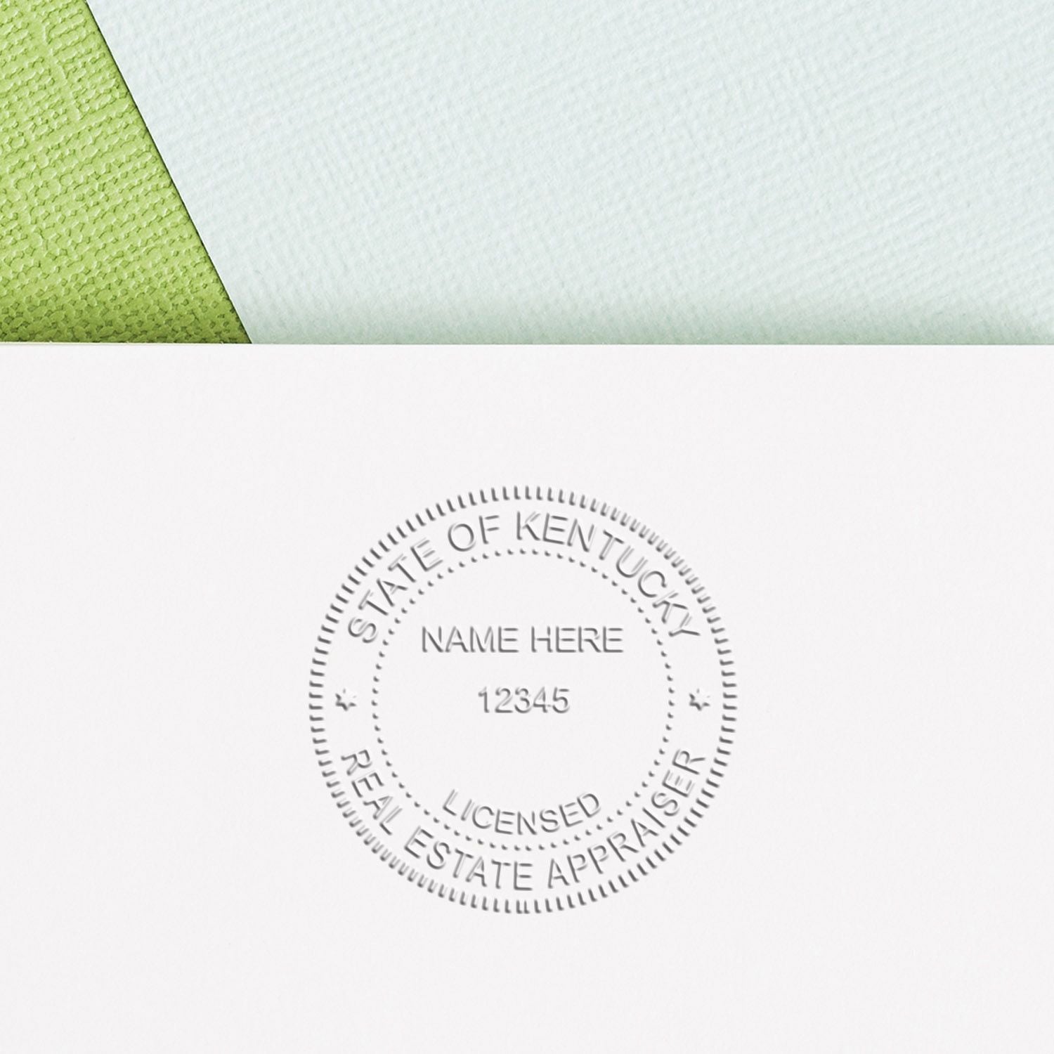 Embossed State of Kentucky licensed real estate appraiser seal on a white document with a green folder corner.