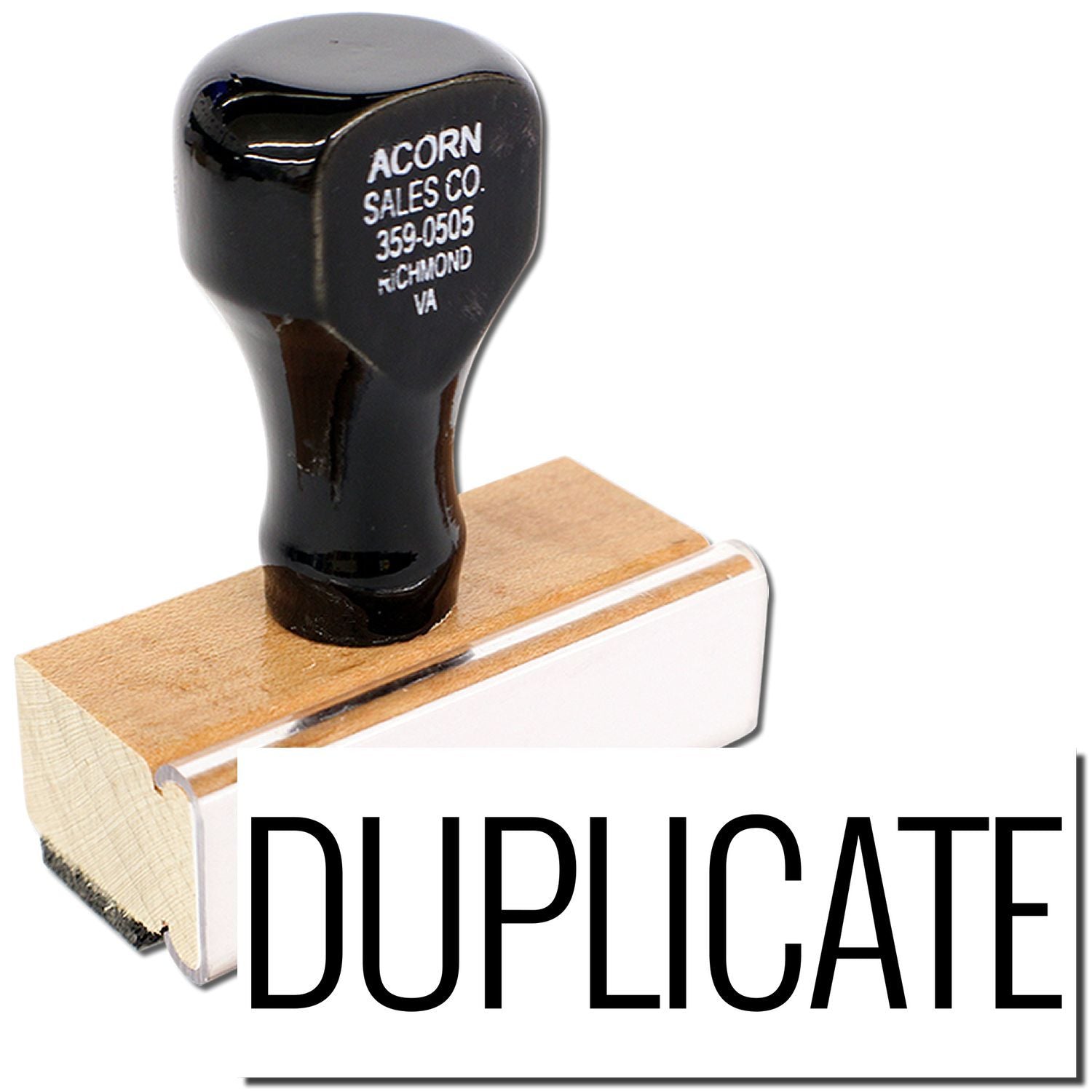 Black Acorn Sales Co. key blank on wooden block labeled DUPLICATE for professional key duplication and locksmith service.