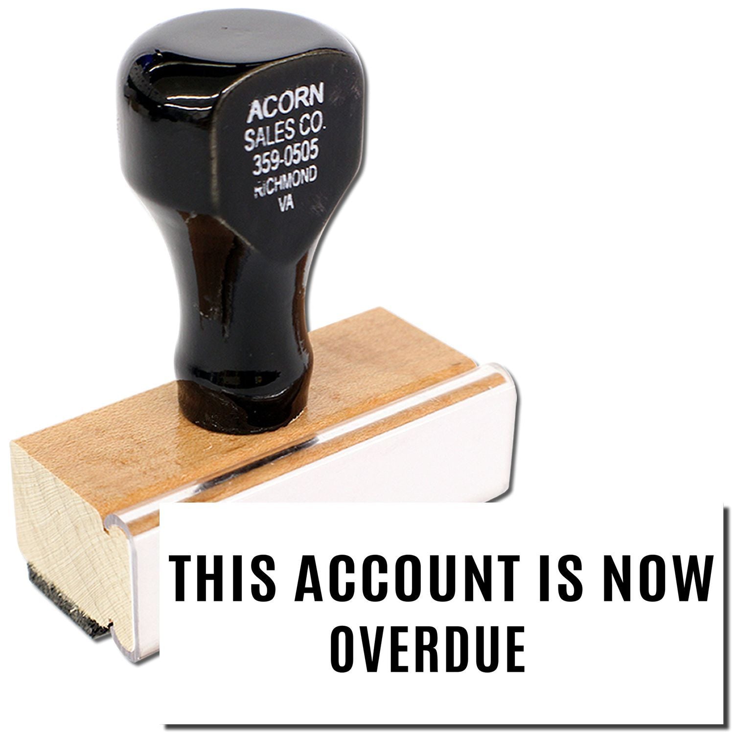 Acorn Sales Co. overdue account notice on a black handle on wood block, indicating delinquent payment status.