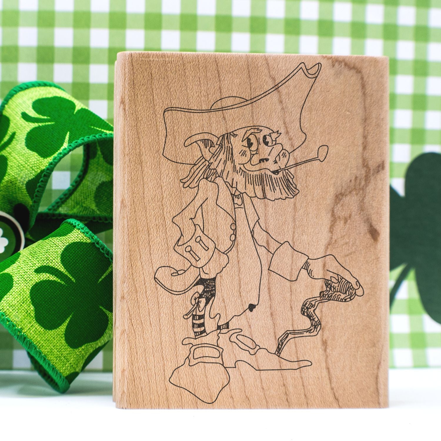 Wooden stamp featuring a leprechaun illustration with green shamrock decor for St. Patricks Day crafts.