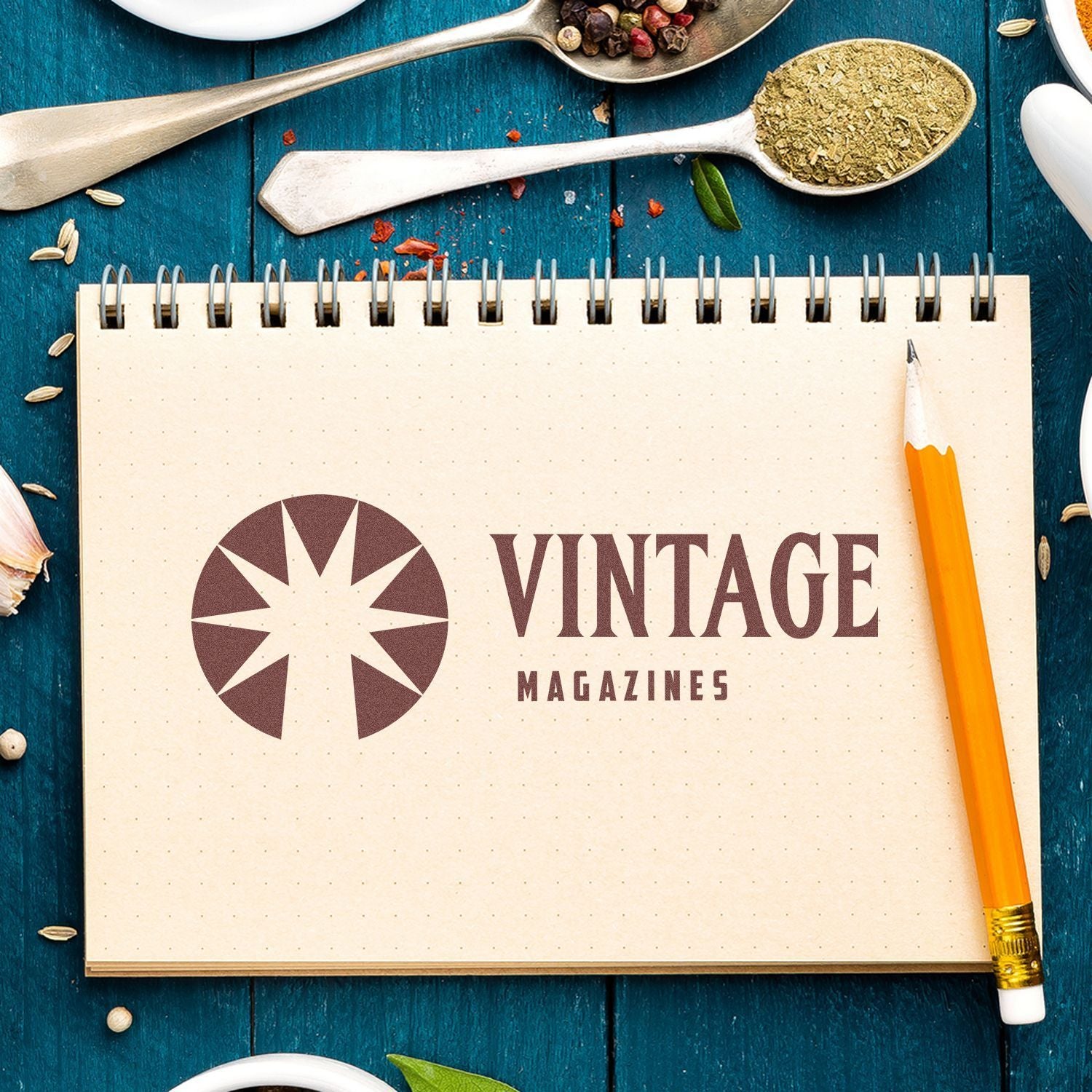 Vintage magazines cover design concept with notebook, pencil, and spices/herbs on a teal background for creative editorial content