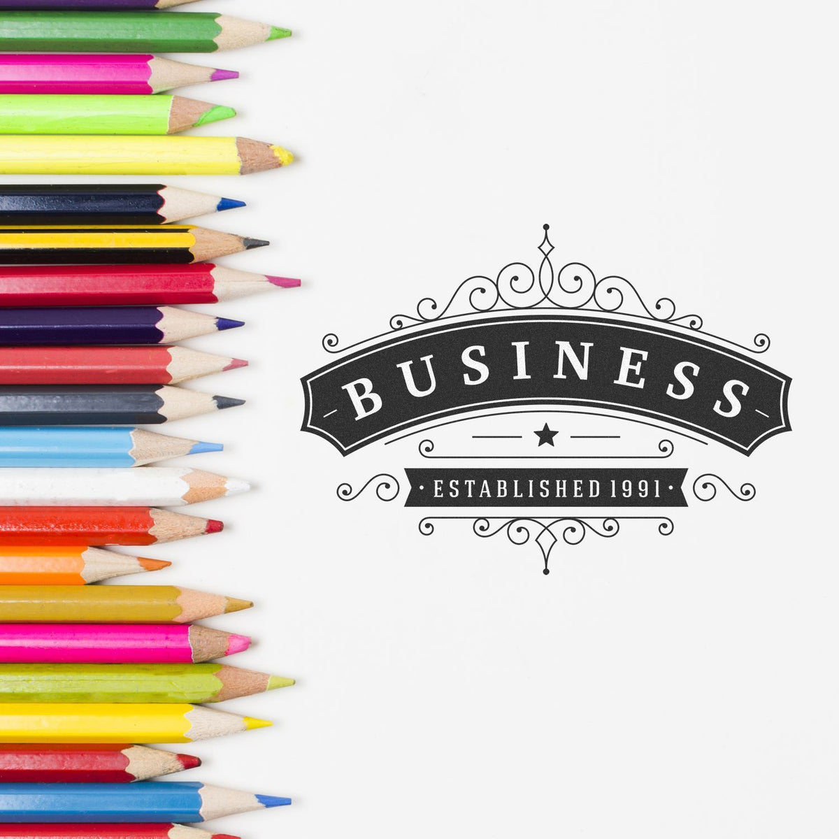 Colorful colored pencils border a white background with decorative Business Established 1991 vintage label.