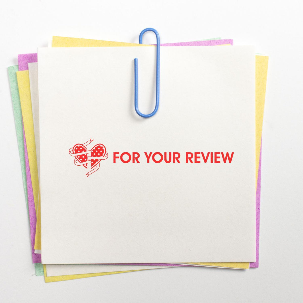 Stack of greeting cards with blue paperclip reading For Your Review, asking for product feedback.