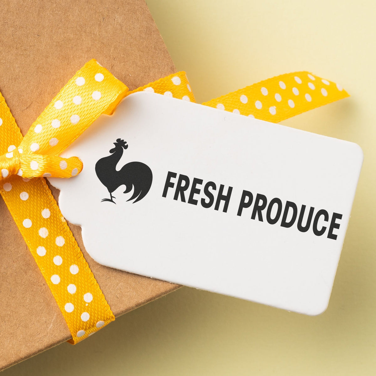 Fresh produce gift tag on kraft paper tied with yellow polka-dot ribbonlabel reading FRESH PRODUCE for grocery delivery.