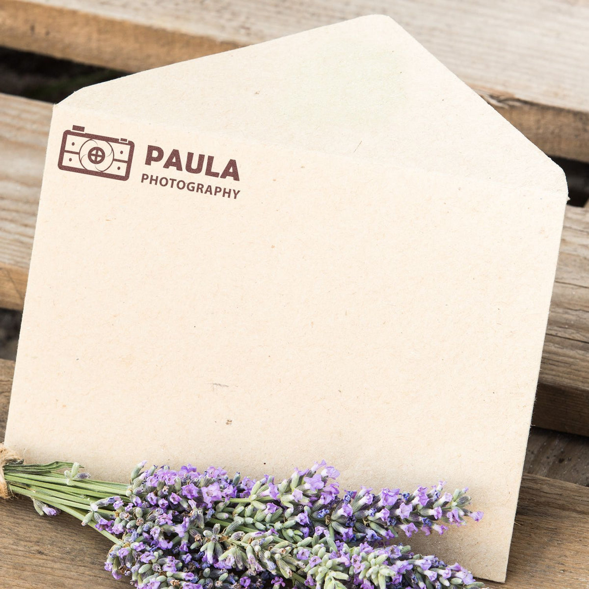 Paula Photography logo on cream paper with lavender flowers, ideal for branding, photography studio website header banner