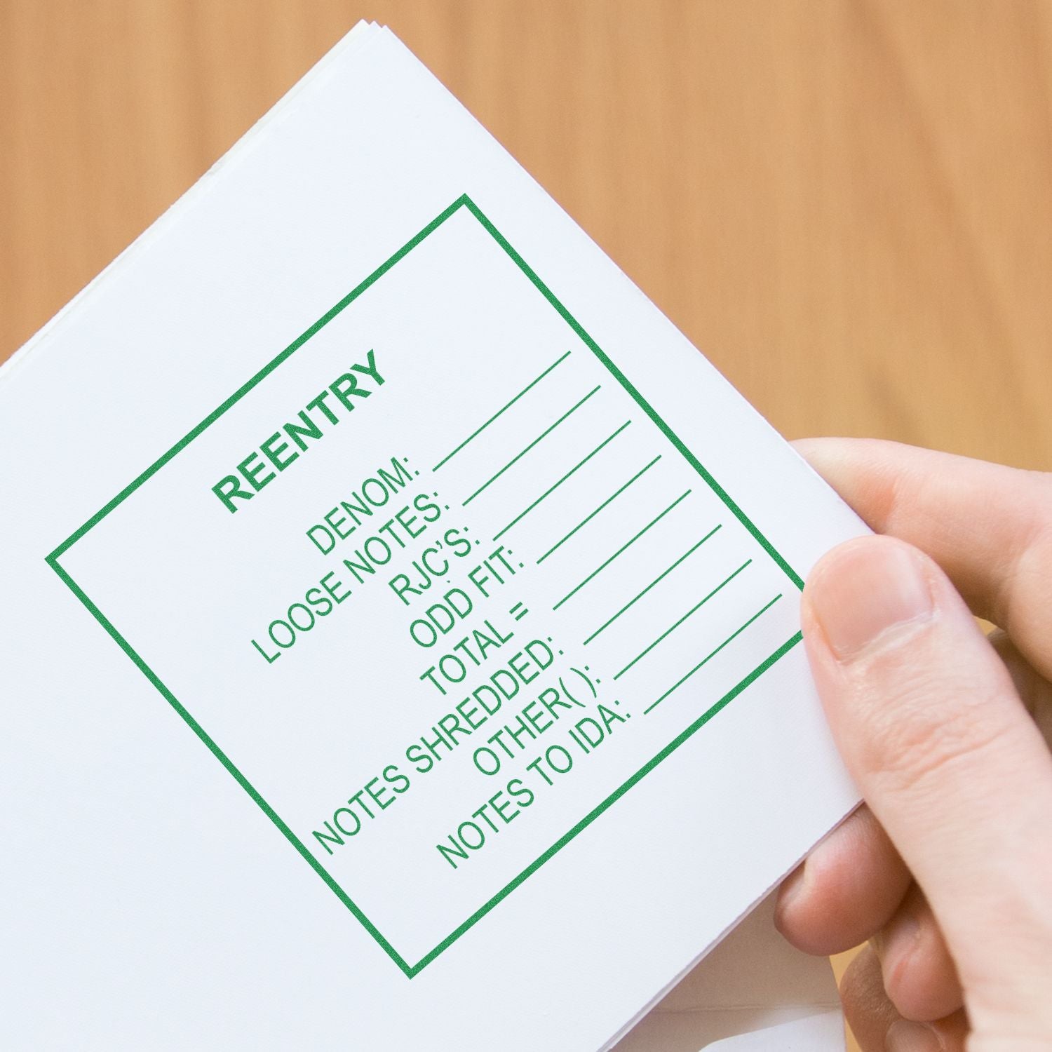 Close-up of hand holding a notepad card labeled REENTRY, with green reminder bullets for notes and rules.