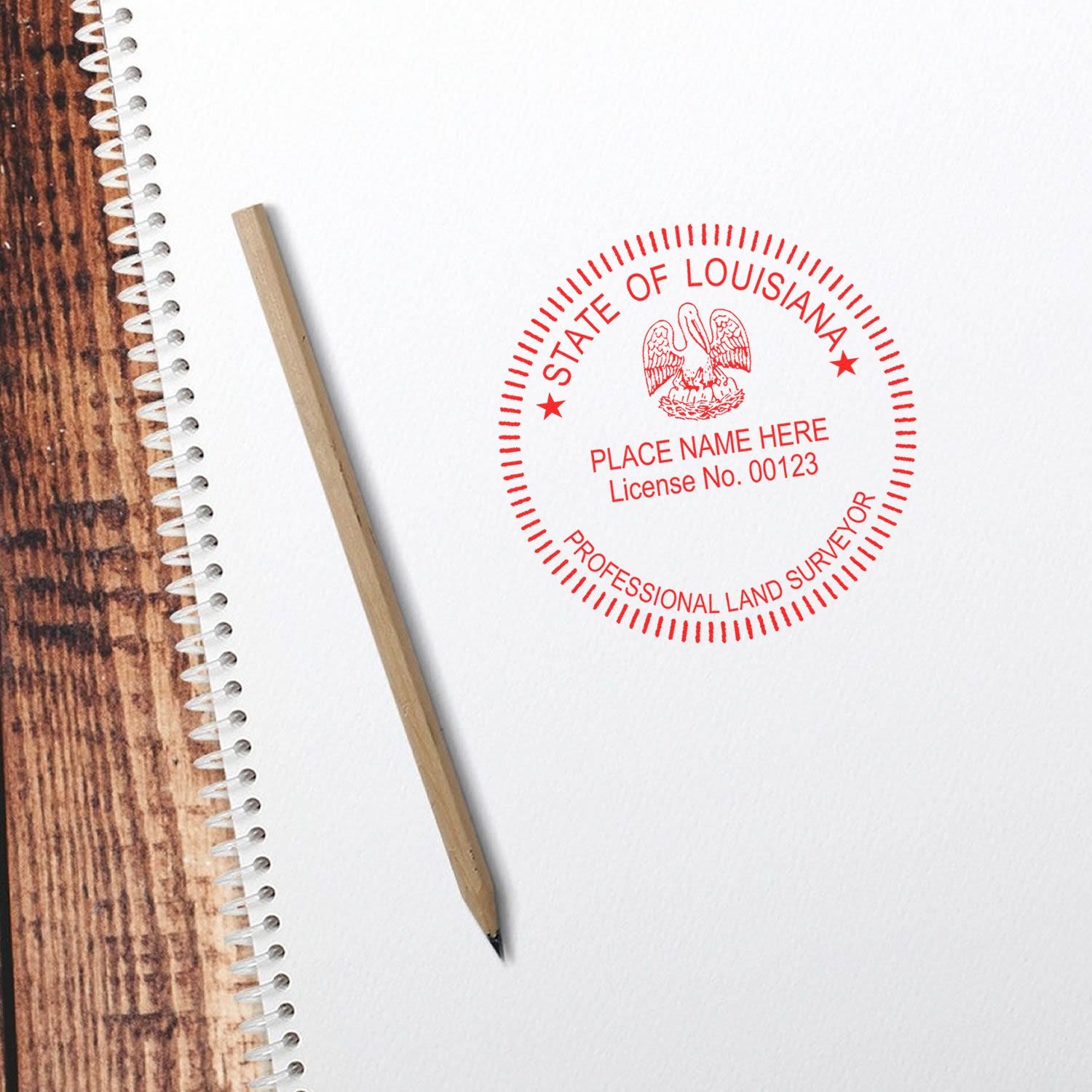Louisiana professional land surveyor stamp on notebook paper with pencil on wooden desk.