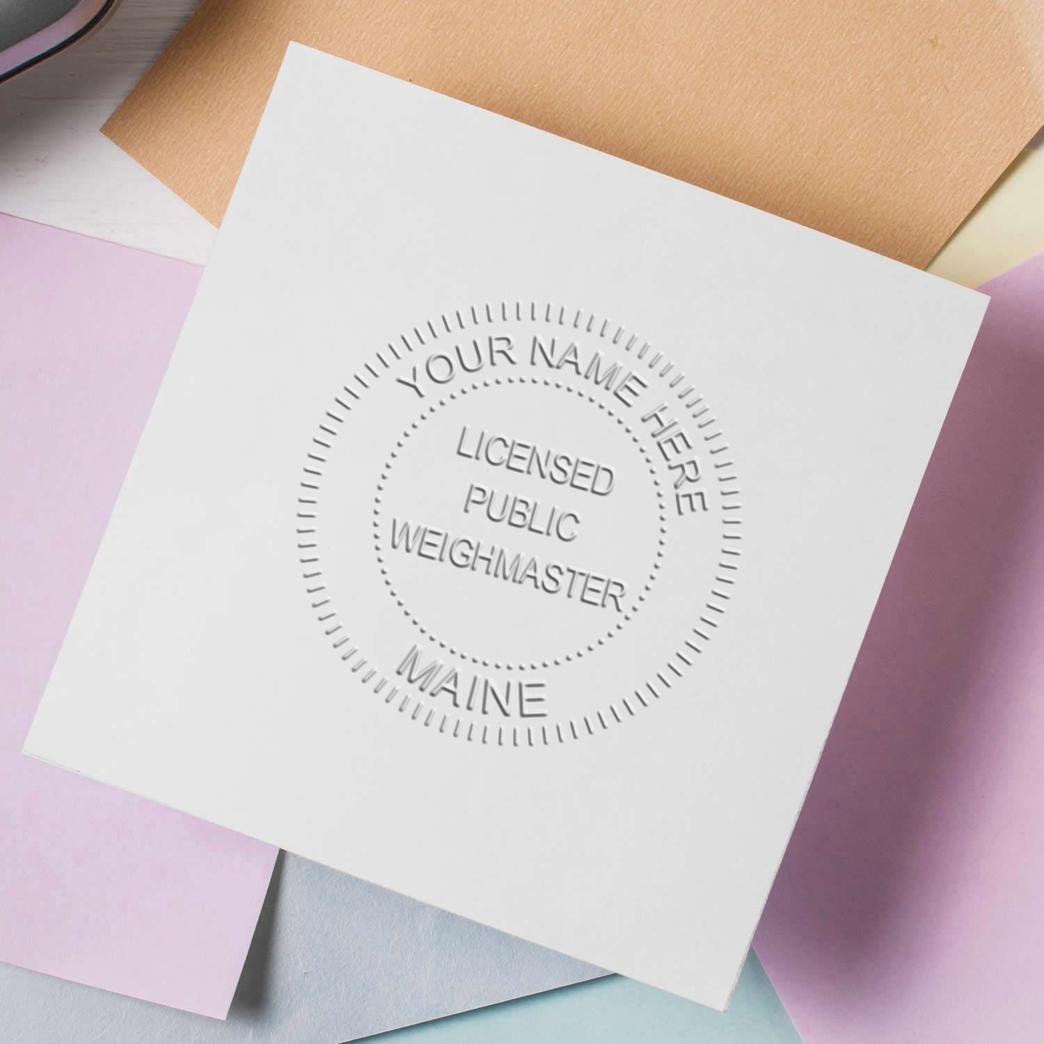Blank embossed business card mockup with Licensed Public Weighmaster Maine seal on pastel background.
