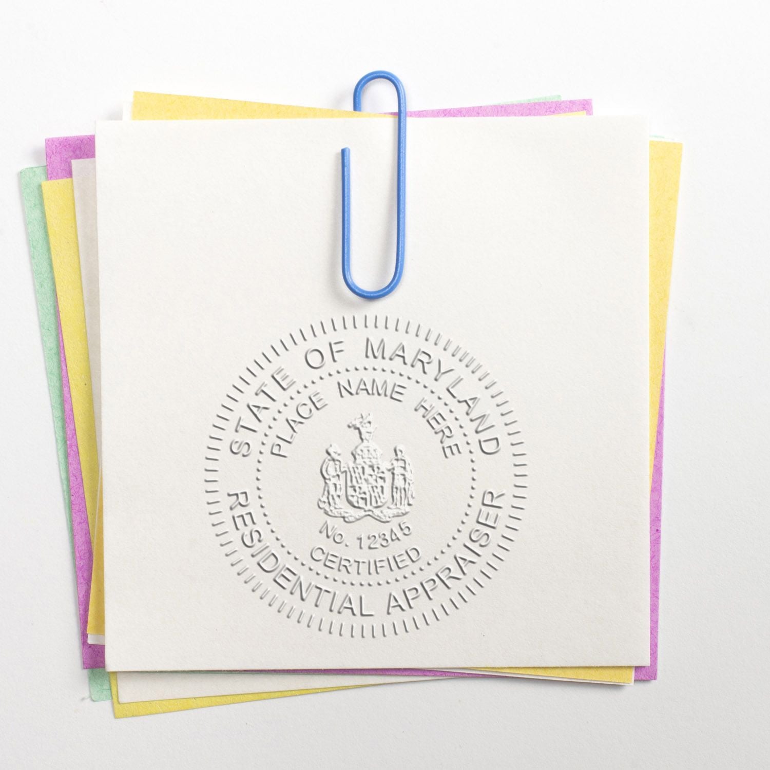 Stack of appraisal documents with State of Maryland certified residential appraiser seal and blue paper clip.