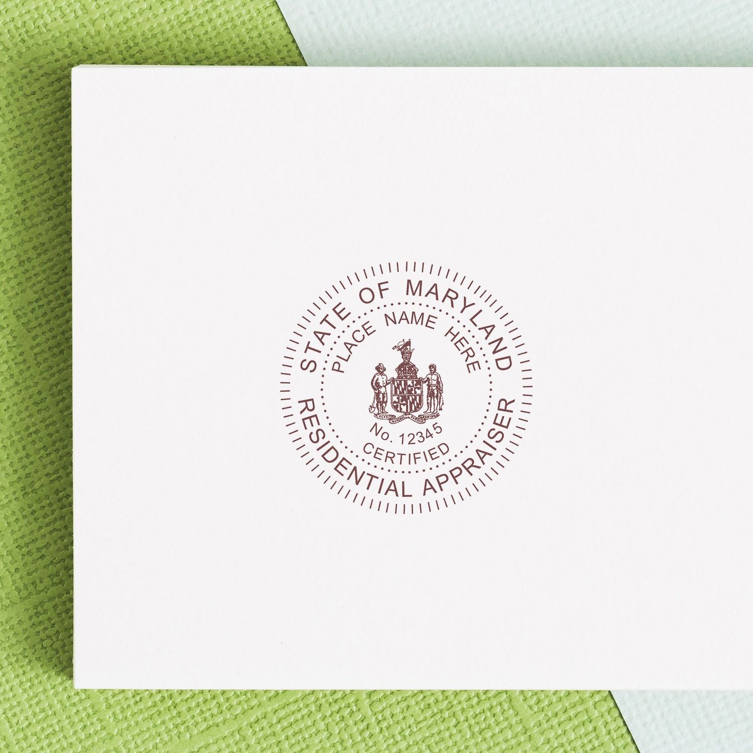 White envelope with State of Maryland Residential Appraiser seal on green textured background
