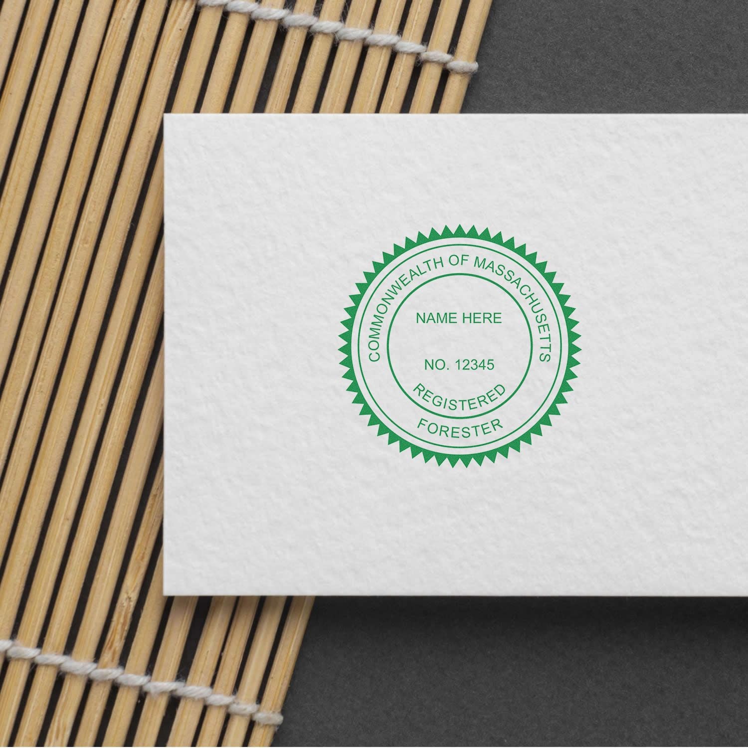 Commonwealth of Massachusetts Registered Forester seal on white certificate paper with bamboo mat background