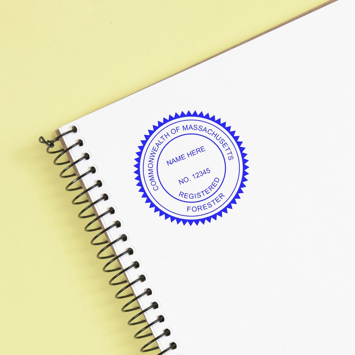 Spiral notebook with Commonwealth of Massachusetts Registered Forester stamp on white cover.