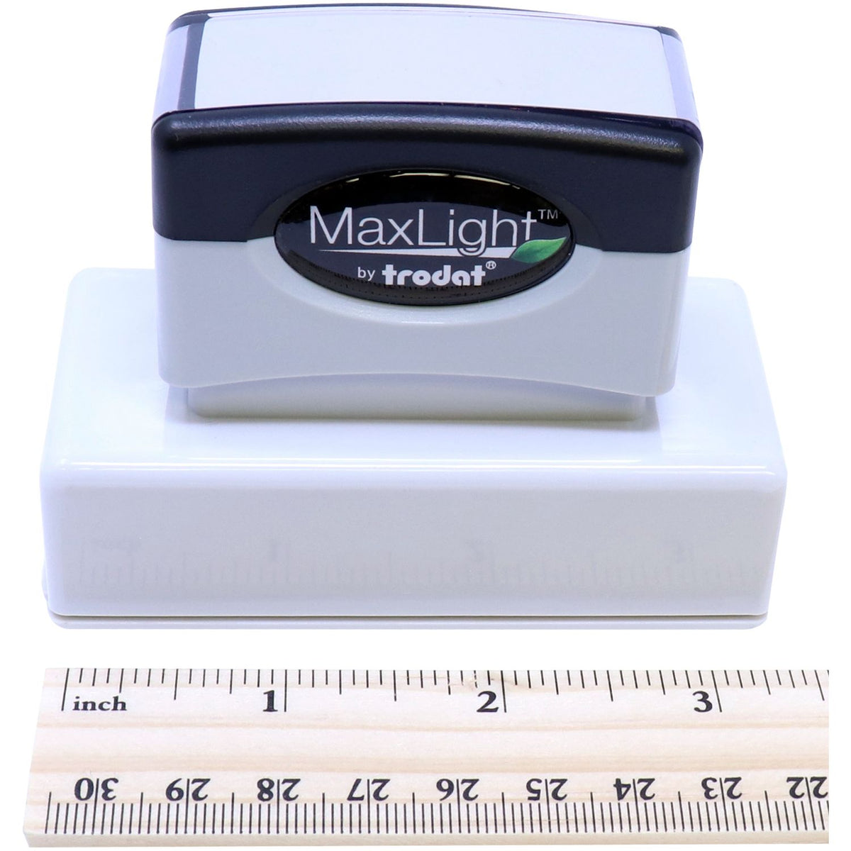 Trodat MaxLight labeling stamp head close-up with size ruler, showing compact product for installation and measurement of dimensions.