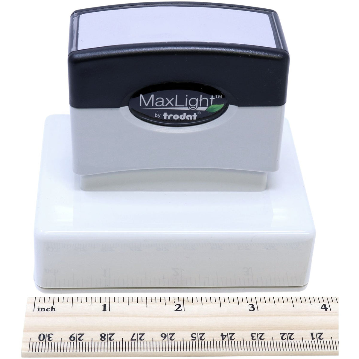 Trodat MaxLight stamp with logo on white base, shown with inches measuring ruler for product size and dimension reference.
