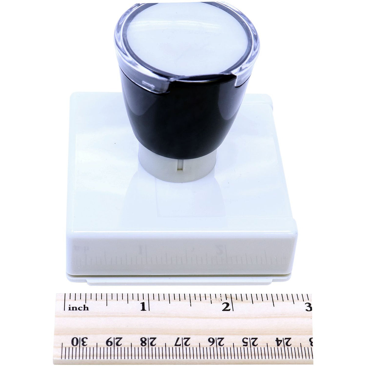 Black and white cylindrical product component shown on ruler for size measurement in inches and centimeters.