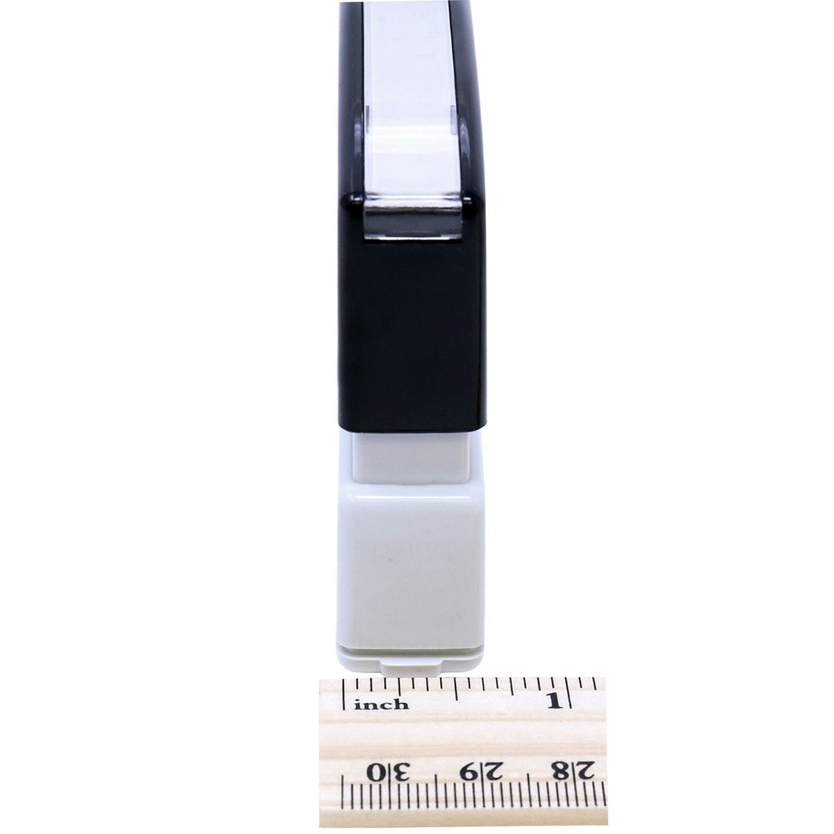 Close-up of a compact black-and-white electronic connector latch, shown with an inch ruler for size and fit reference.