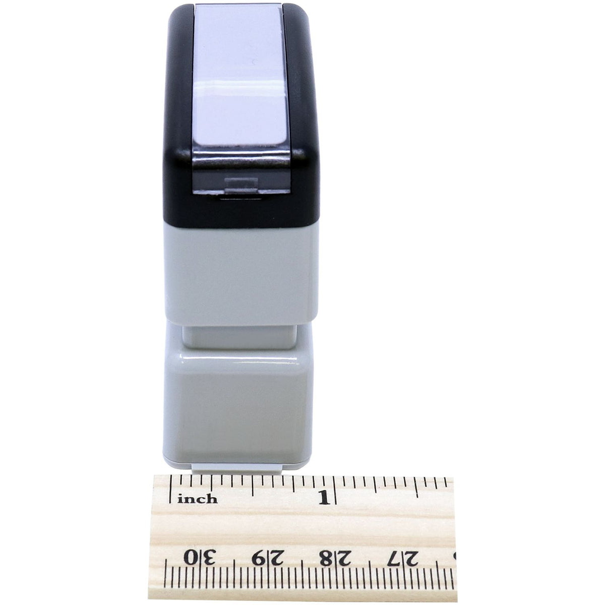 Compact electronic accessory device connector shown on measuring ruler for size reference in close-up product photo.