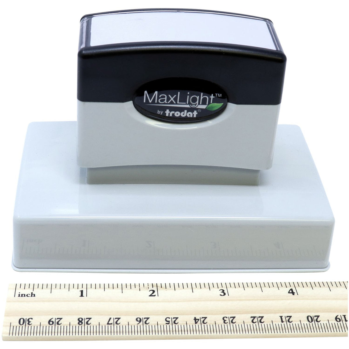 Trodat MaxLight stamp head with branding and size shown beside inch ruler for accurate product identification