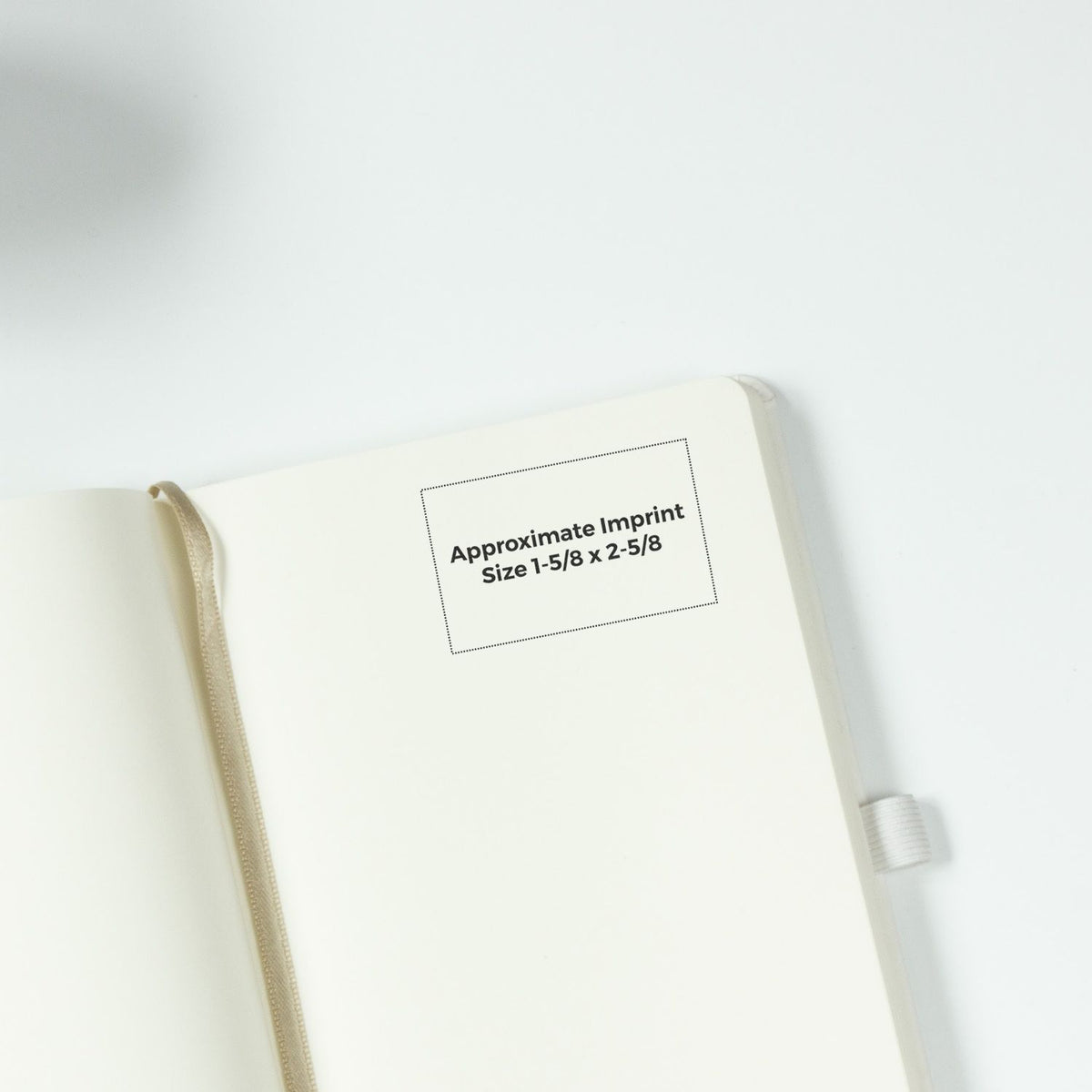 Open cream hardcover notebook with ribbon bookmark and custom imprint area, showcasing approximate imprint size 1-5/8 x 2-5/8.