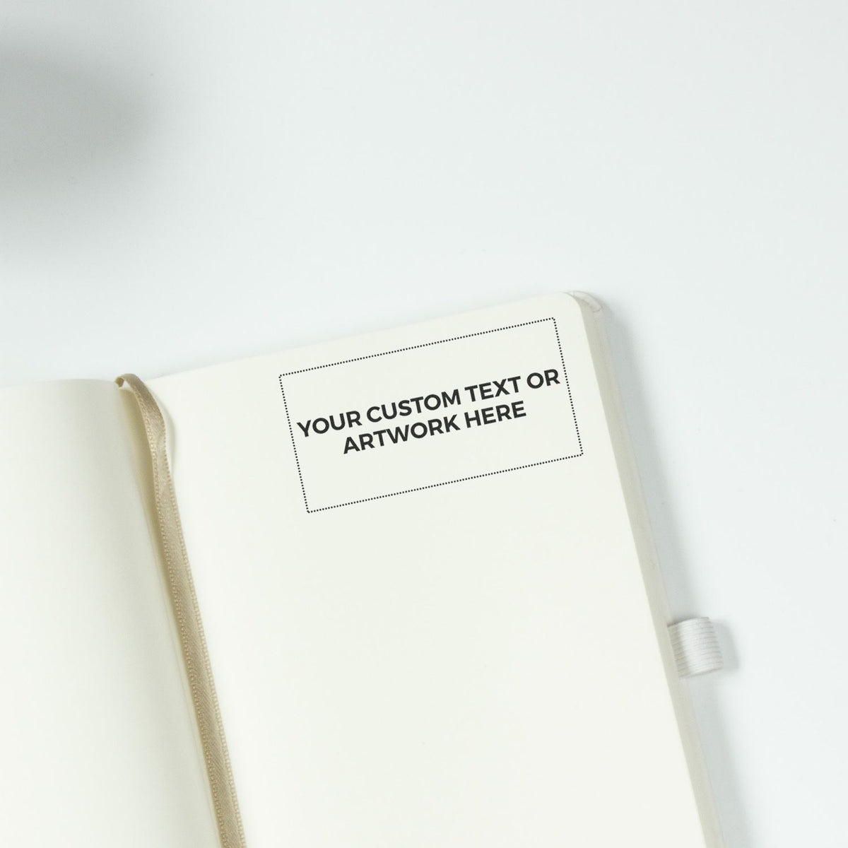 Open white notebook mockup with custom text or artwork placeholder on a clean minimalist background.