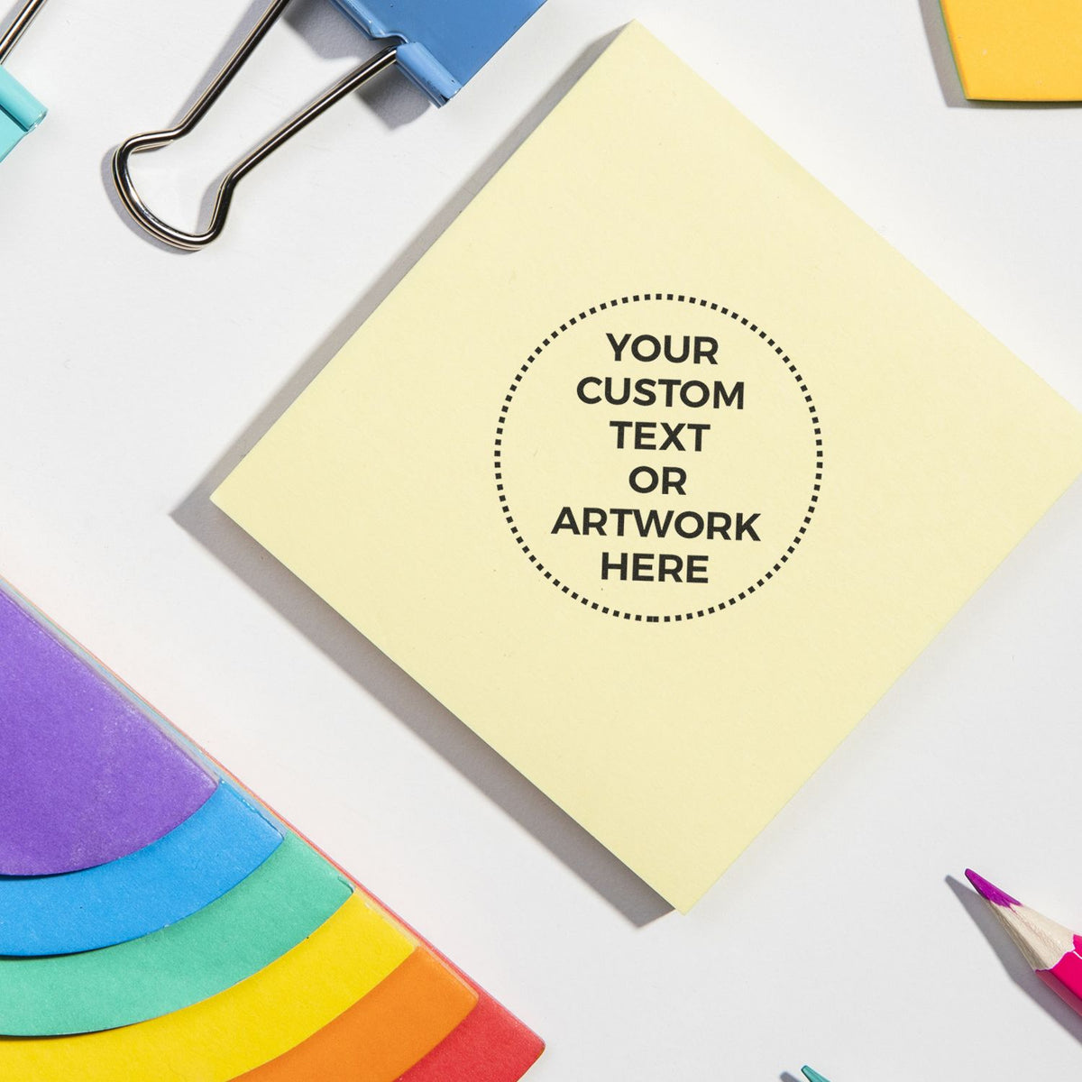 Yellow note template for custom text or artwork, with stationery supplies like paperclips and colored pencils for branding mockup