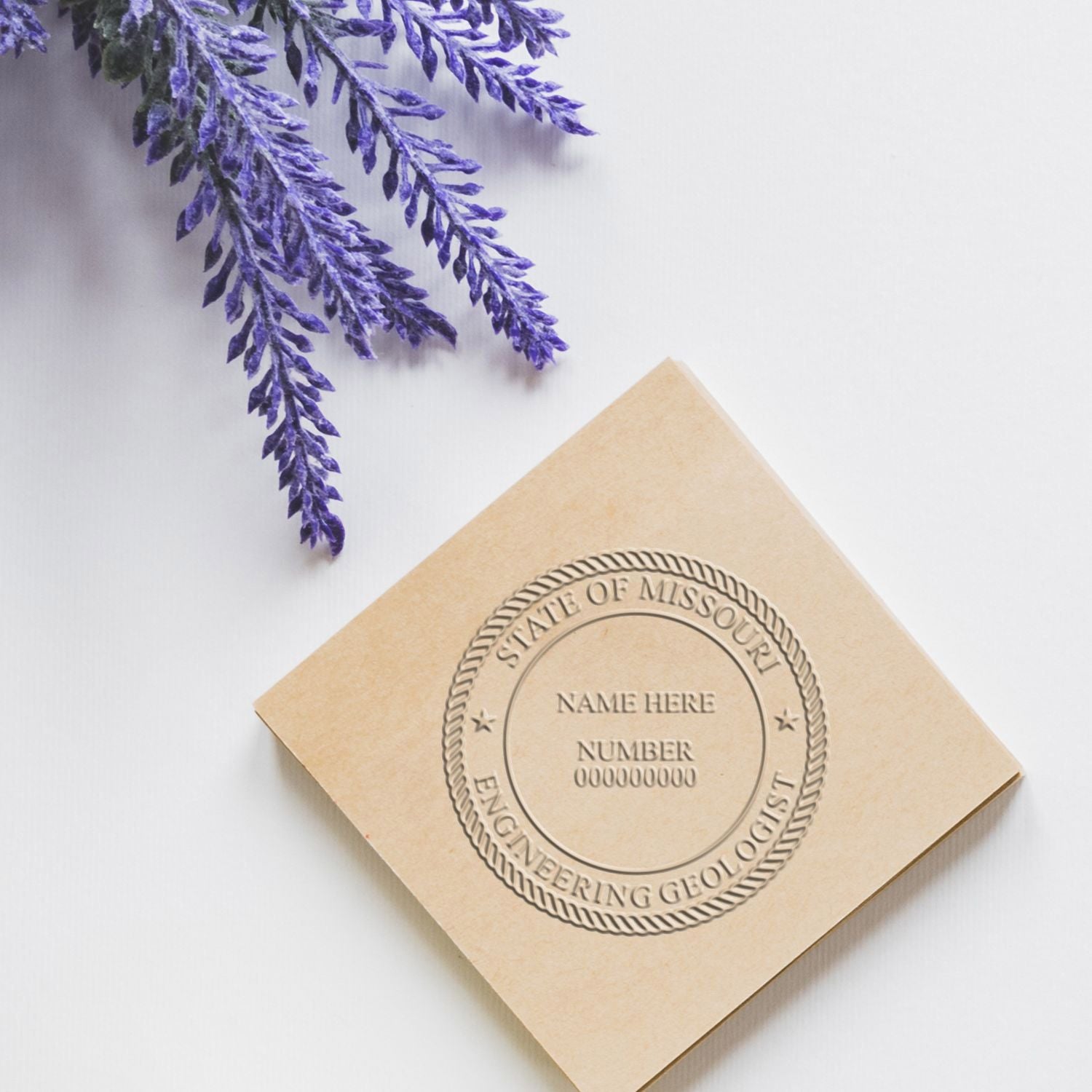 Embossed State of Missouri engineering geologist seal on beige paper with purple floral accents on a white background