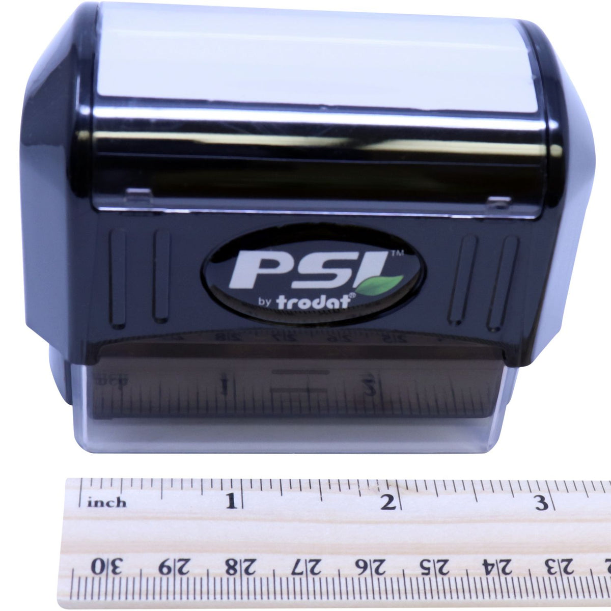 Trodat PSI self-inking stamp on white background with inch ruler showing compact size and dimensions.