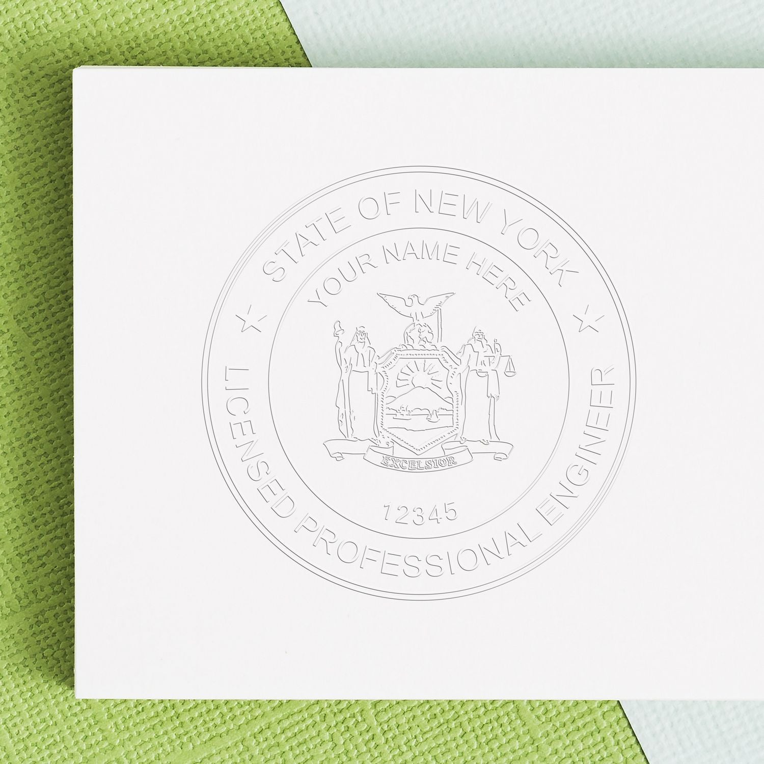 Embossed New York State professional engineer license seal on white paper with green textured background.