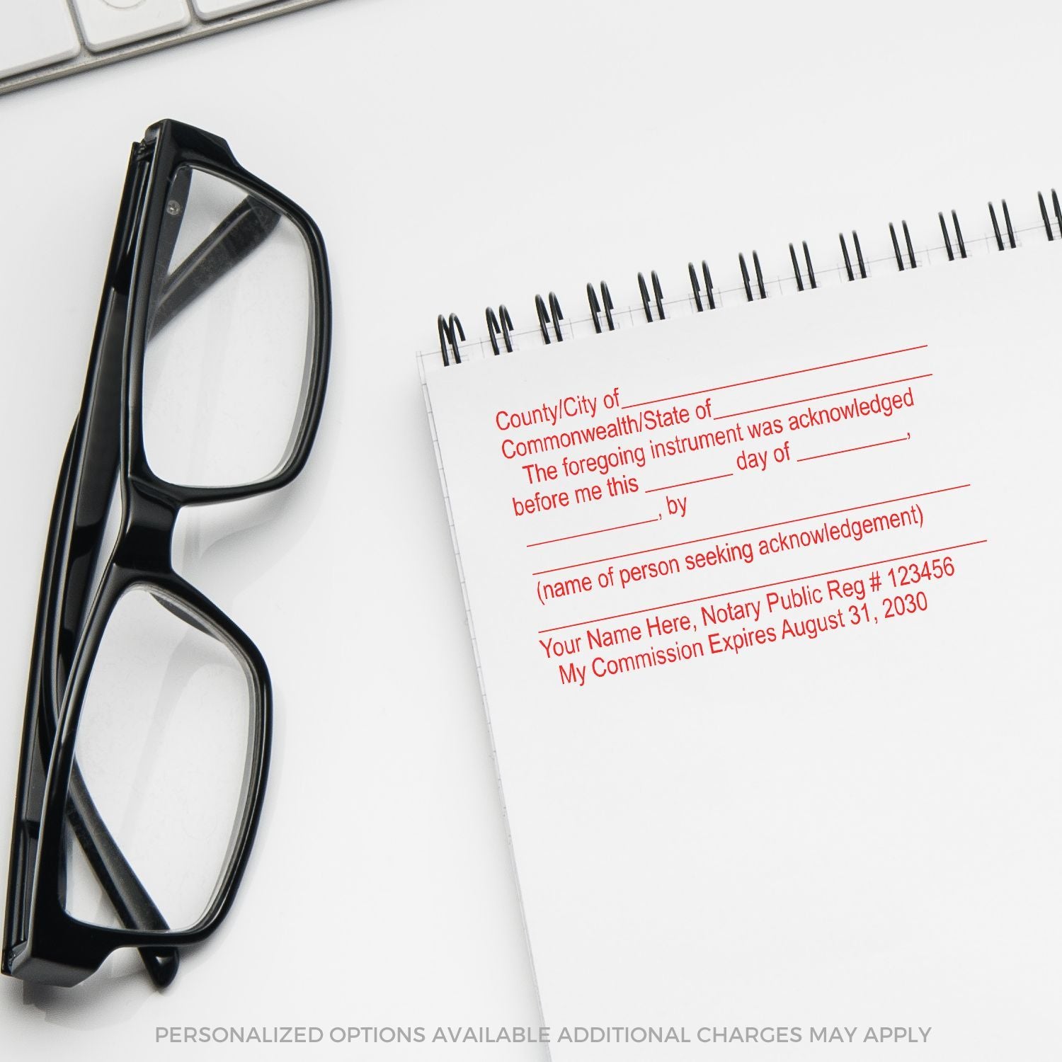Notary acknowledgment stamp beside eyeglasses and notebook on a clean office desk, legal document preparation concept.