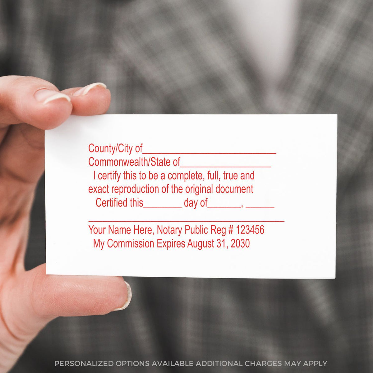 Hand holding a notary public business card with custom certification text and commission expiration date template.
