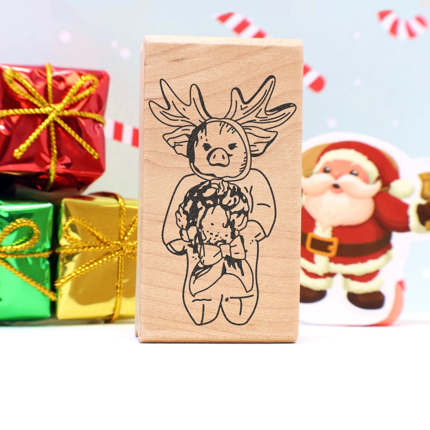 Wooden Christmas stamp featuring a cute reindeer design, with wrapped holiday gifts and Santa Claus decor in the background.