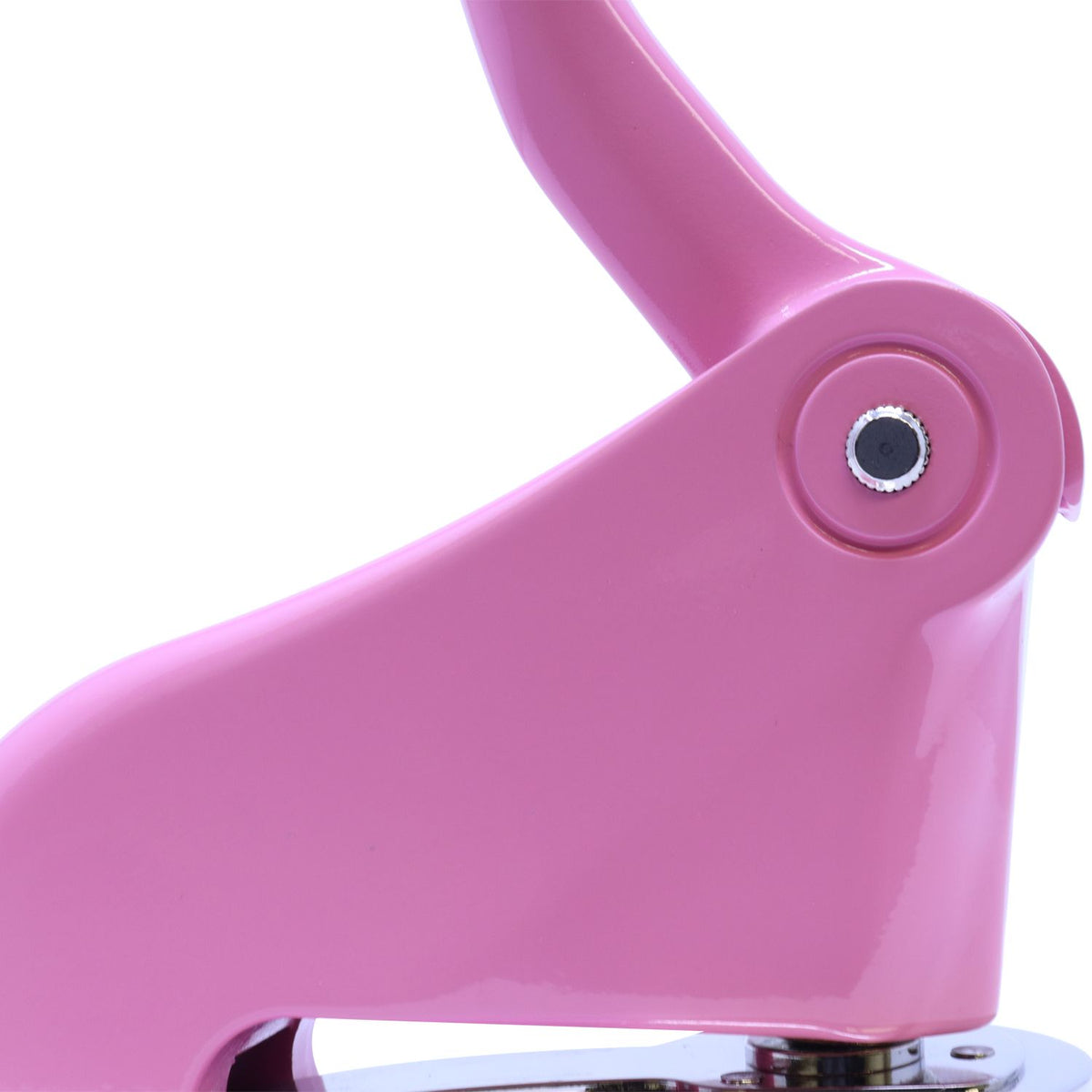 Close-up of a pink paper hole punch with metal lever on a white background.