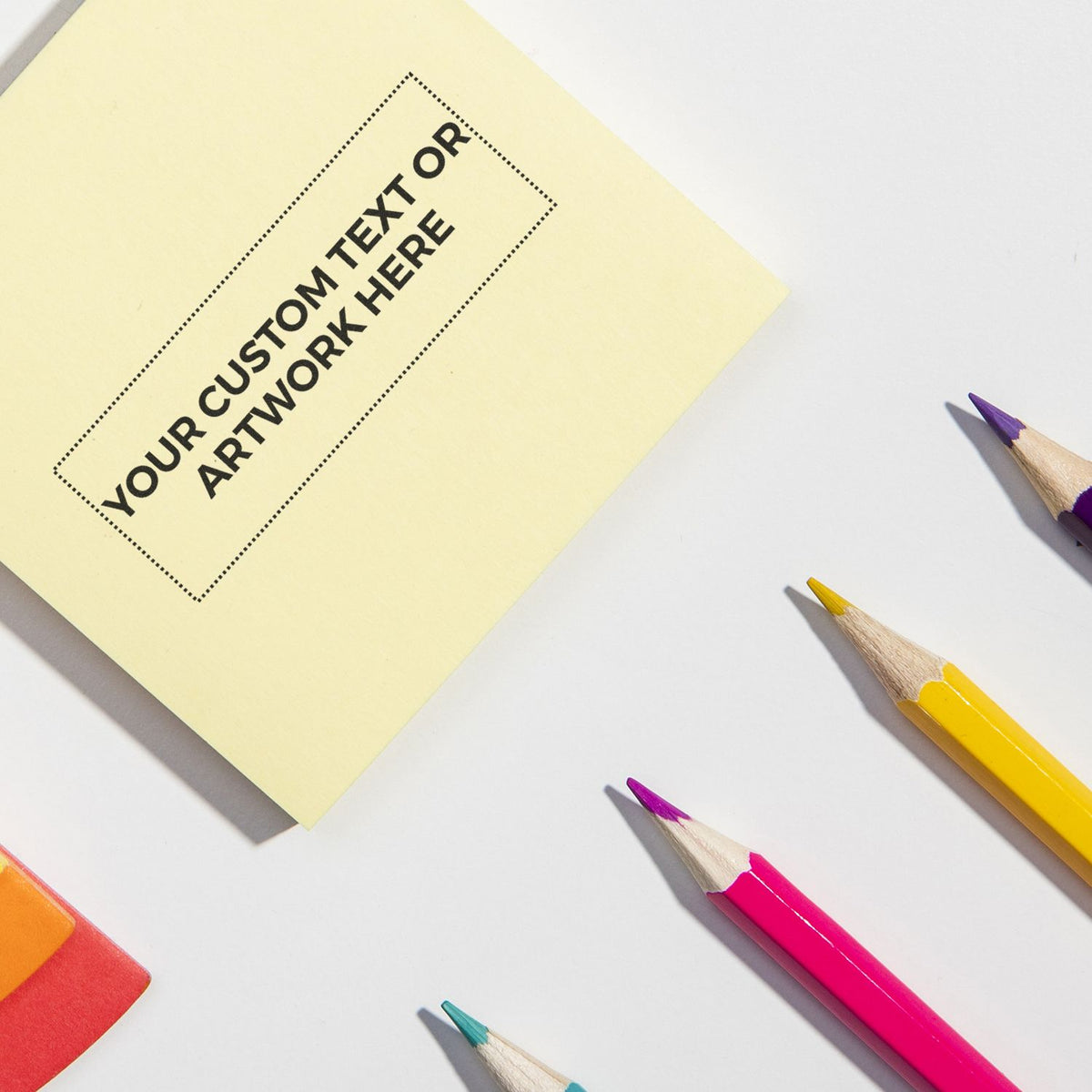 Design placeholder note reading Your Customer Artwork Here with colored pencils, representing custom artwork submission for print projects.