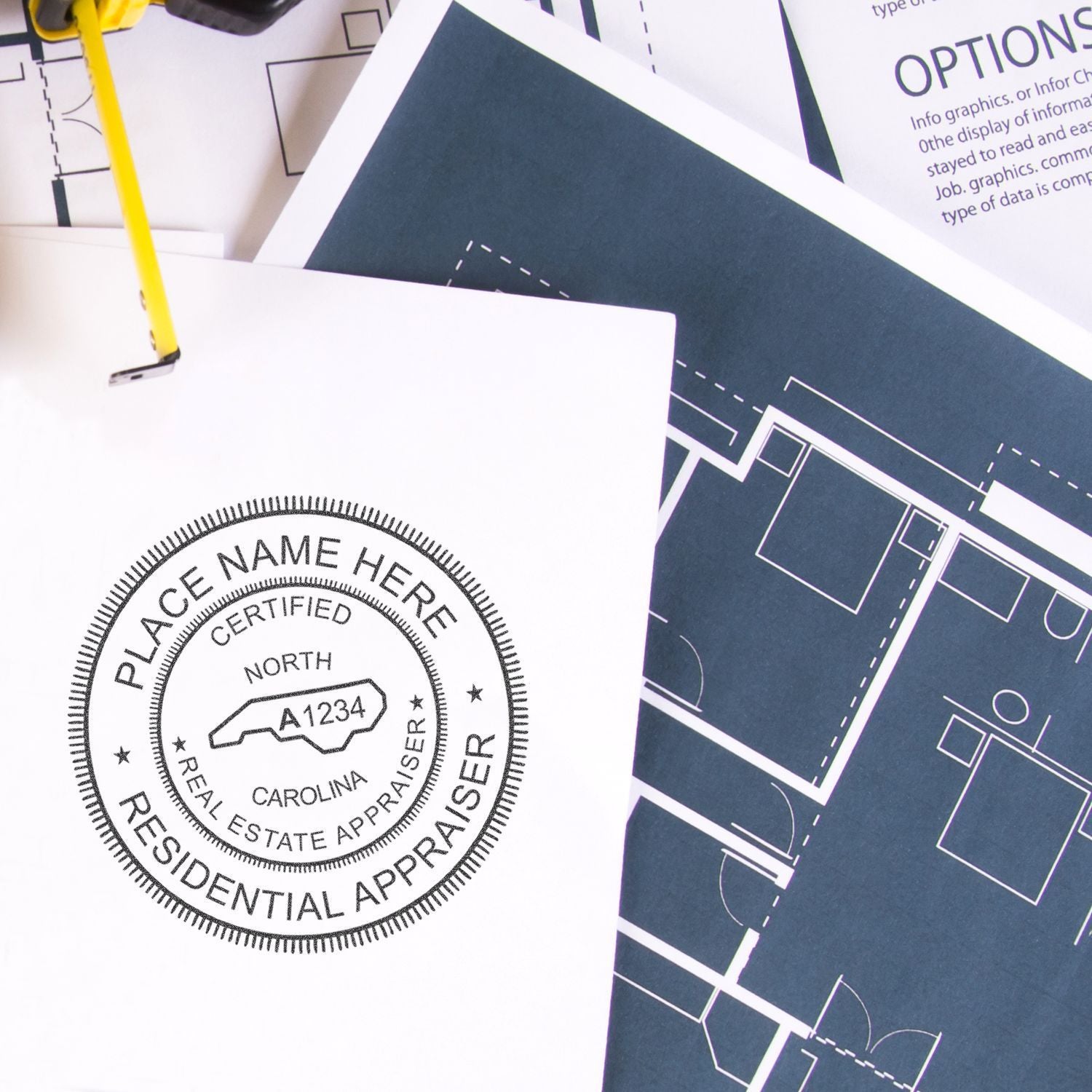 Residential real estate appraisal stamp on architectural floor plan blueprints with pen.