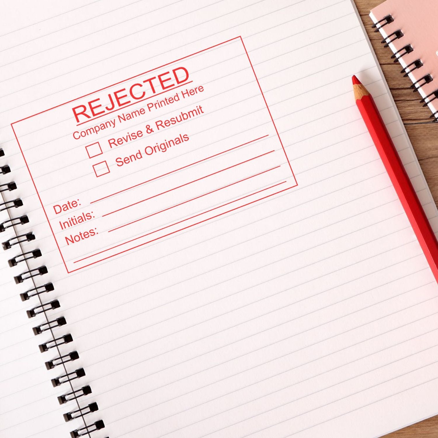 Rejected stamp on lined notebook page with red pencil, office paperwork revision concept