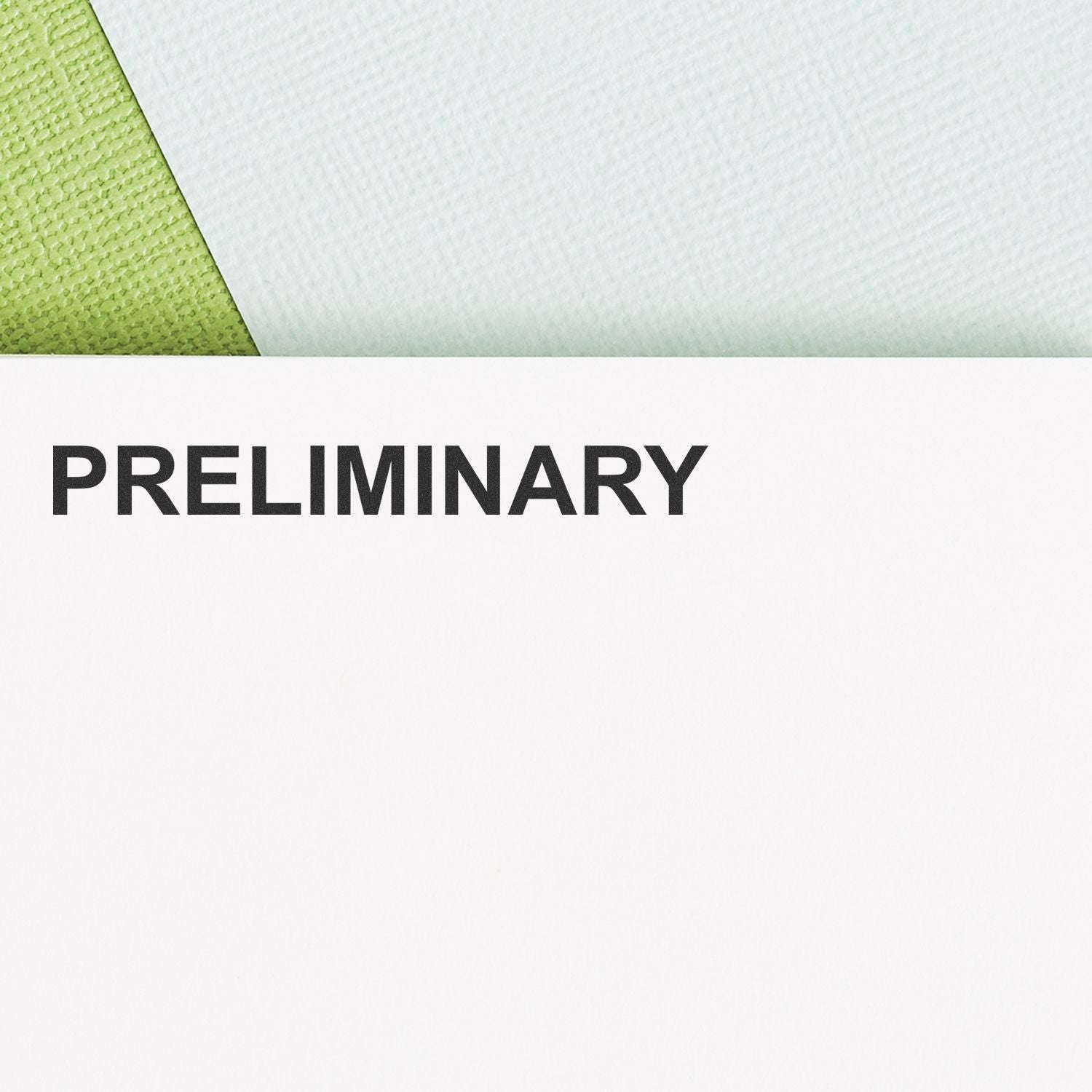 Close-up of a preliminary document page with green textured corner and bold black text on white paper.