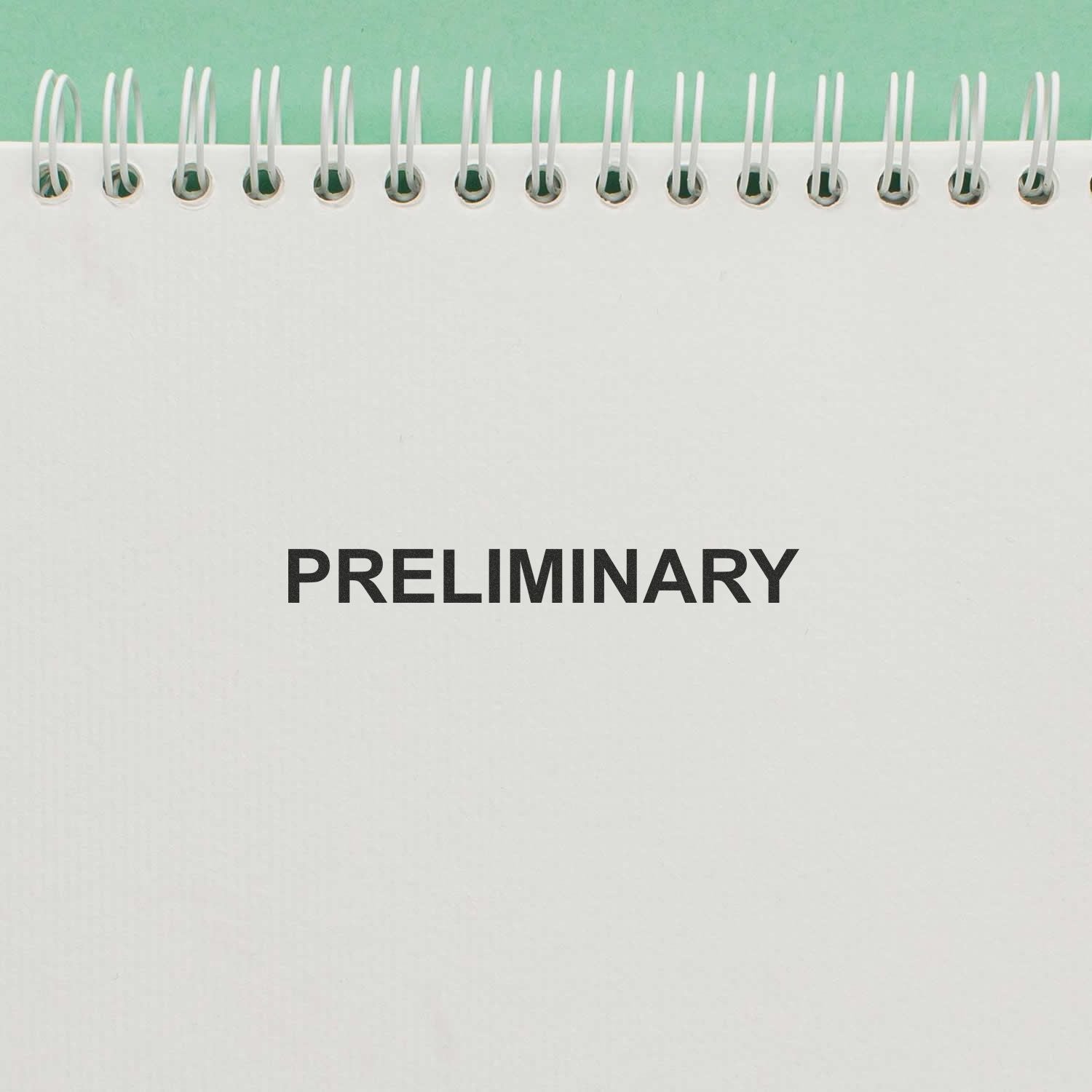 Spiral-bound notebook cover with PRELIMINARY title on a clean blank page design.