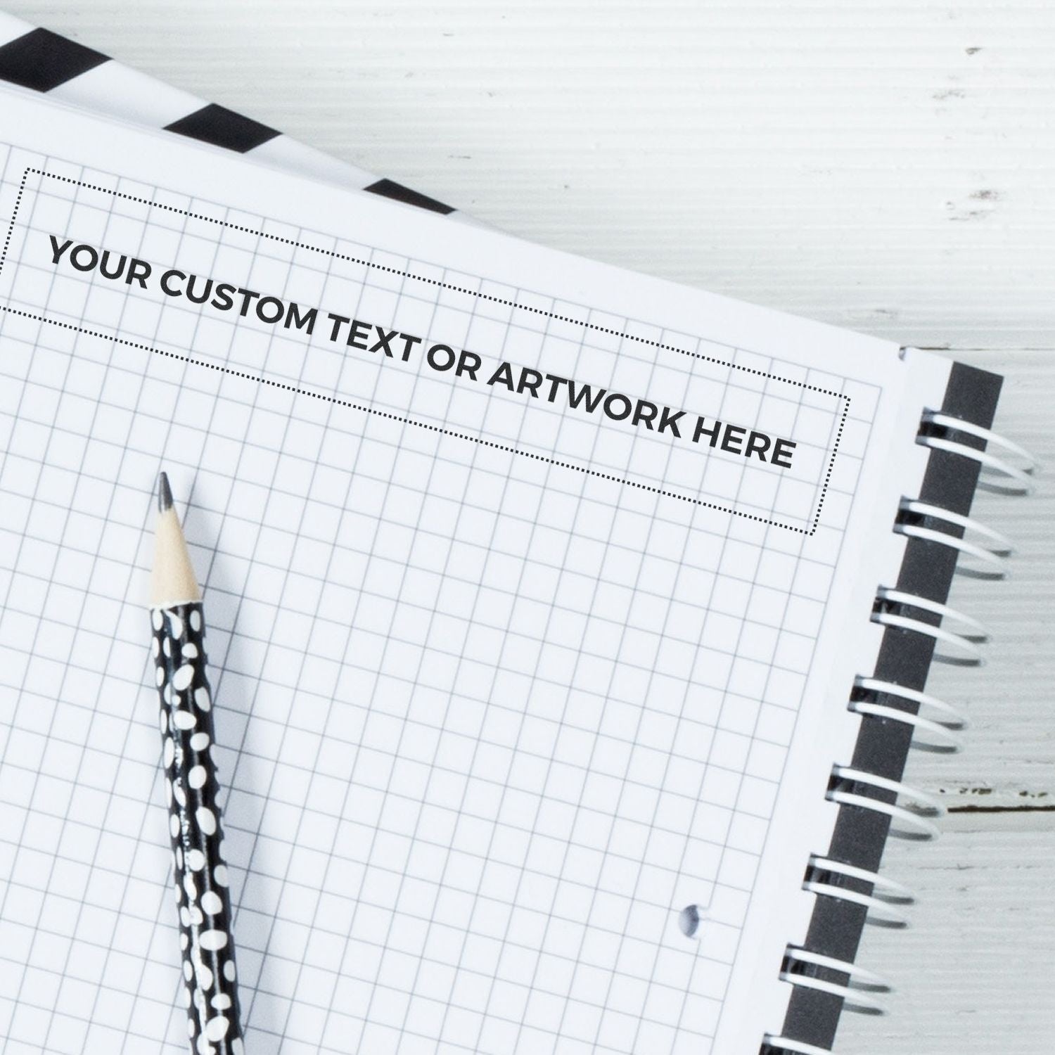 Notebook page template with dotted frame for your custom text or artwork, featuring a pencil and ready for branding design mockups.